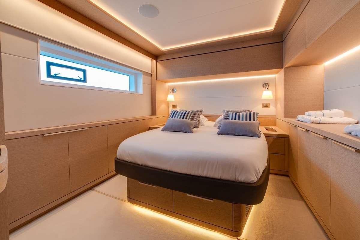 a room with a bed and a desk aboard SEVENTY8 Yacht for Charter