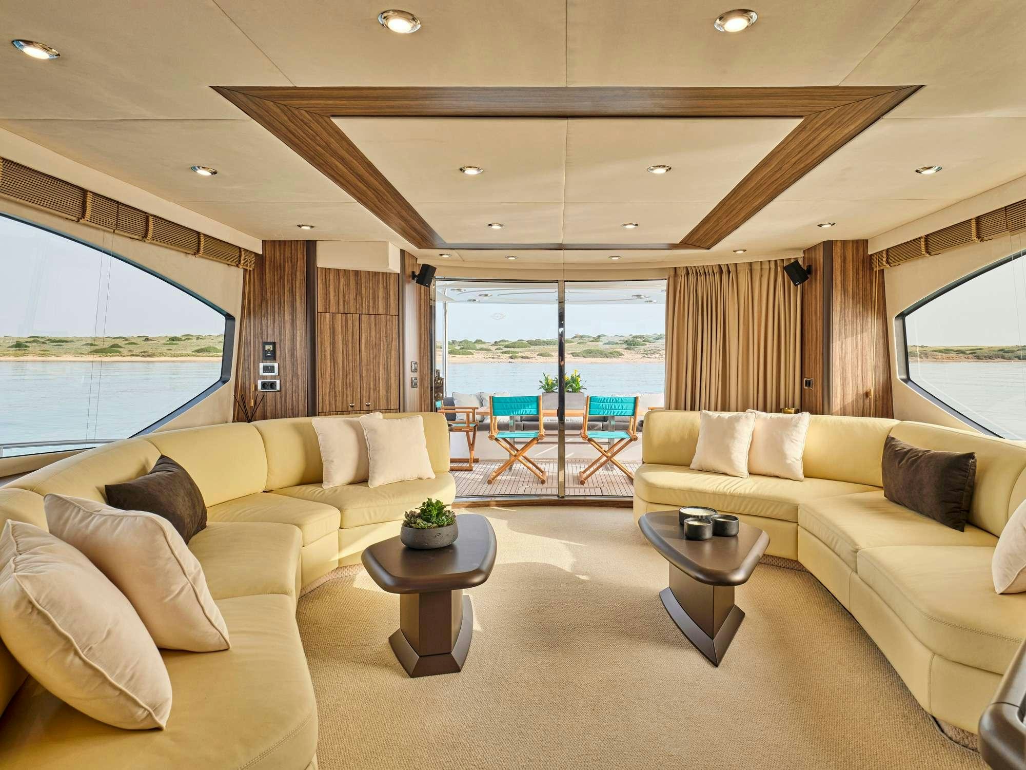 a living room with a large window aboard M FIVE Yacht for Charter