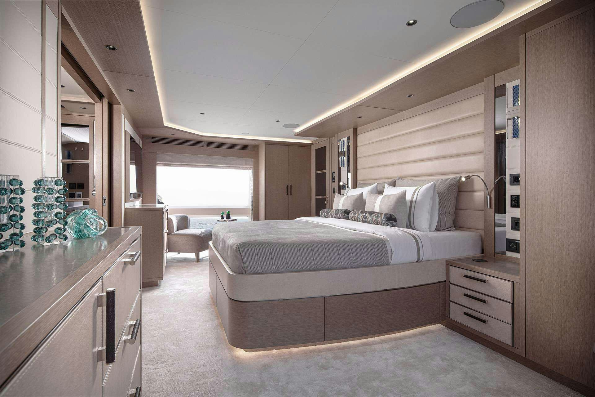 a bedroom with a bed and a desk aboard SAINT Yacht for Charter