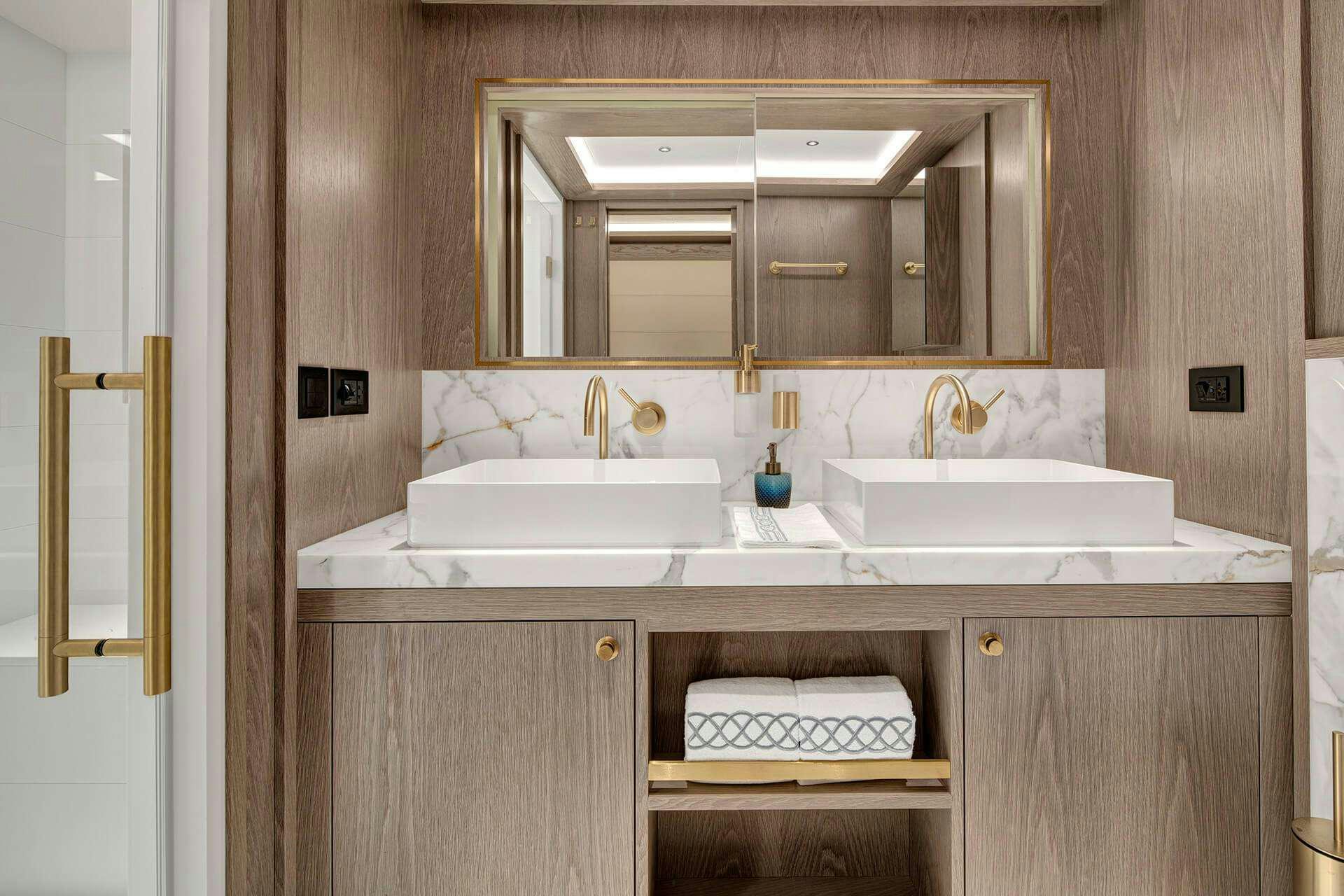 a bathroom with a sink and a mirror aboard SAINT Yacht for Charter