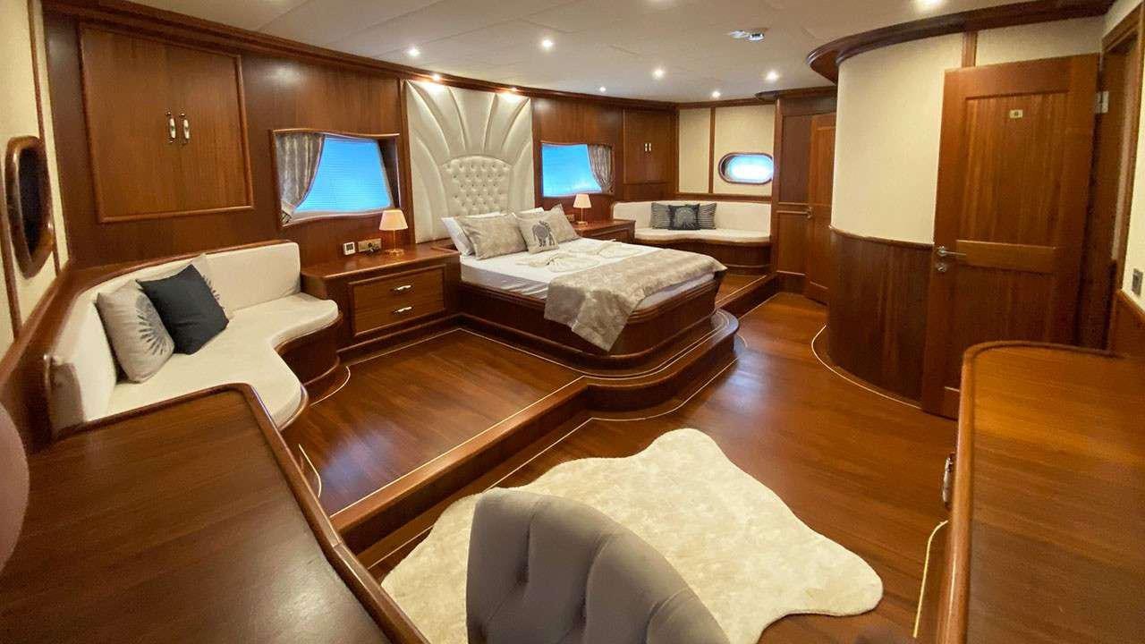 a room with a bed and a couch aboard LA MIA STELLA Yacht for Charter