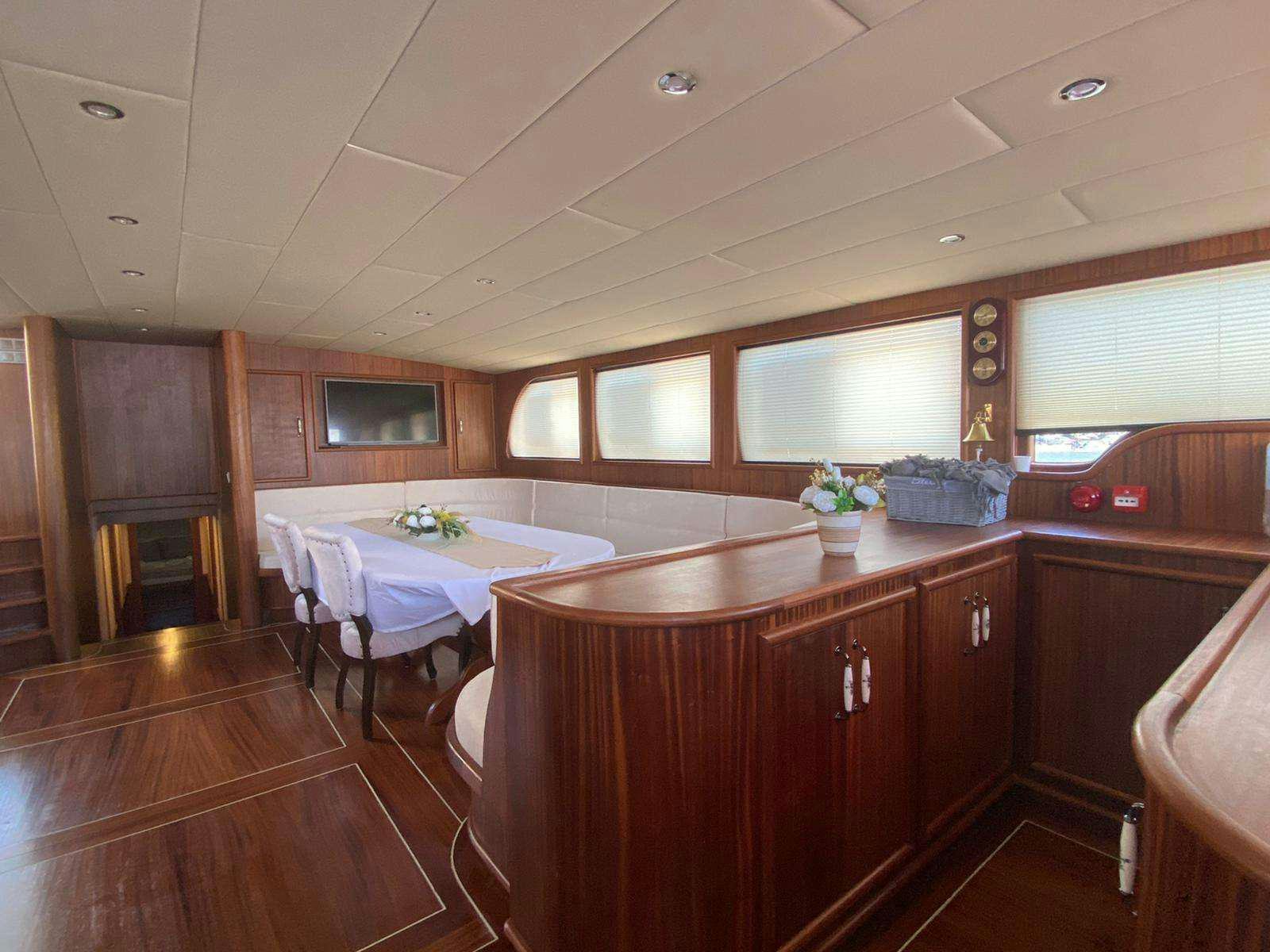 a kitchen with a table and chairs aboard LA MIA STELLA Yacht for Charter