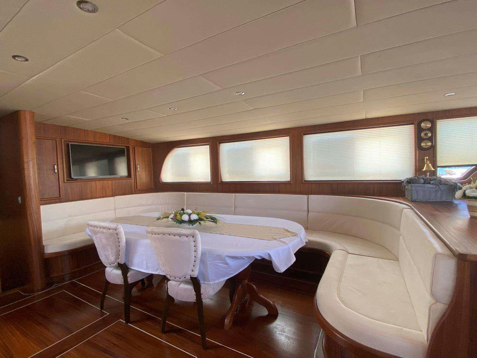 a room with a table and chairs aboard LA MIA STELLA Yacht for Charter