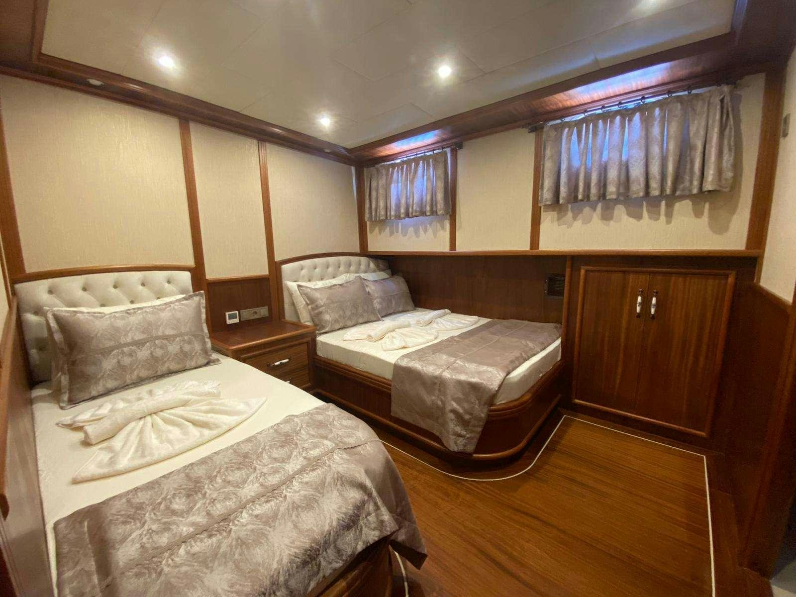 a couple of beds in a hotel room aboard LA MIA STELLA Yacht for Charter