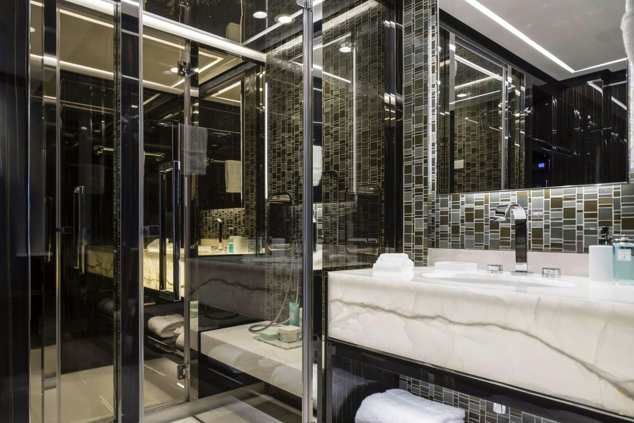 a bathroom with a large glass shower aboard ANDIAMO Yacht for Charter