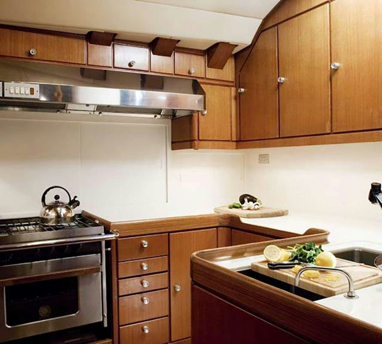 a kitchen with wooden cabinets aboard ABEON Yacht for Charter