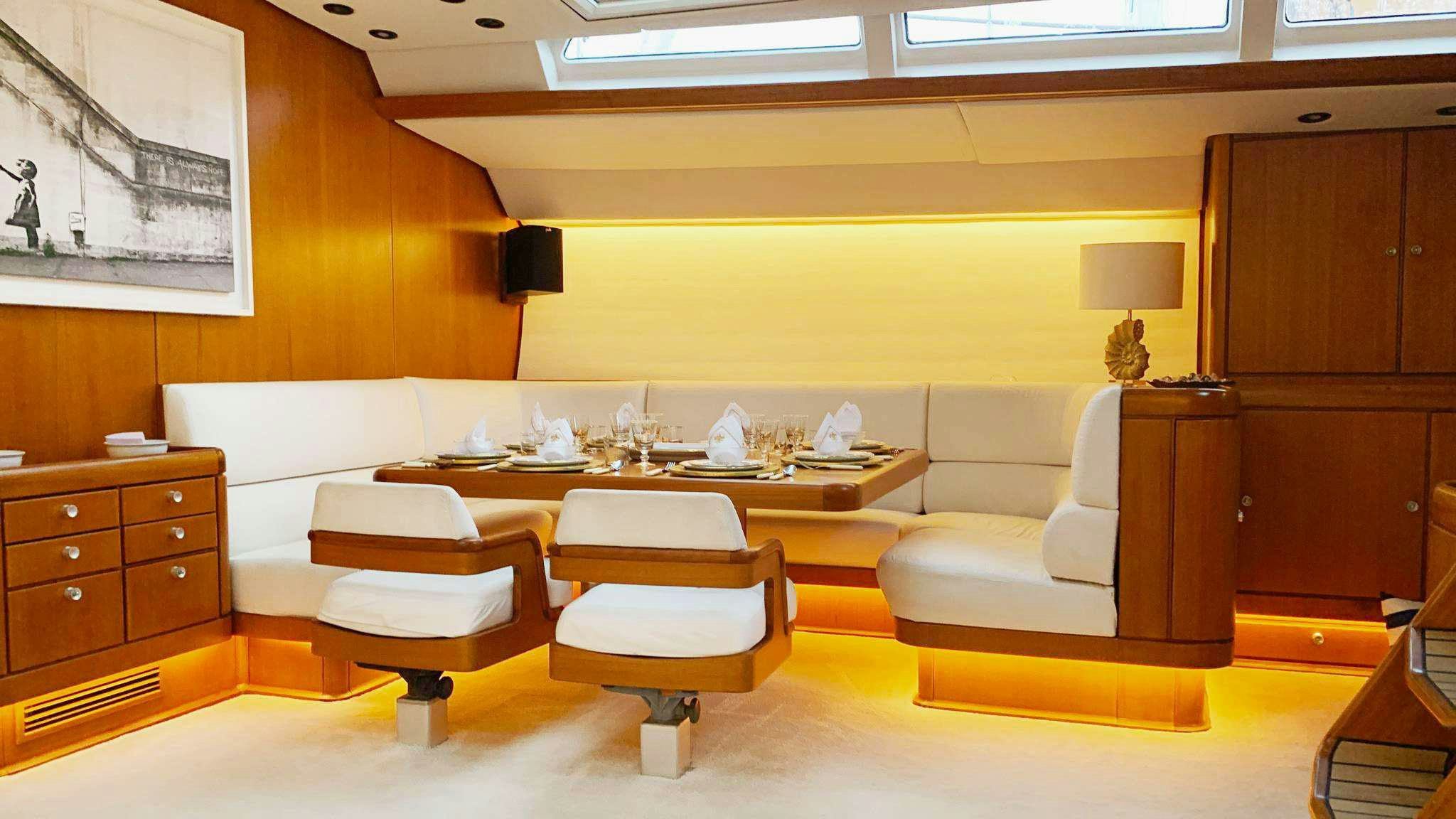 a room with a couch and a table aboard ABEON Yacht for Charter