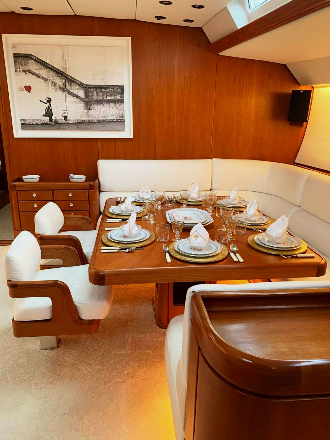 a table with plates and glasses on it aboard ABEON Yacht for Charter
