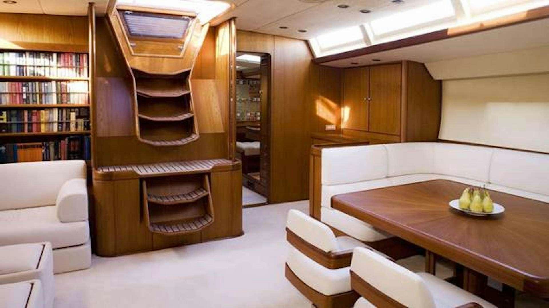a room with a table and chairs aboard ABEON Yacht for Charter