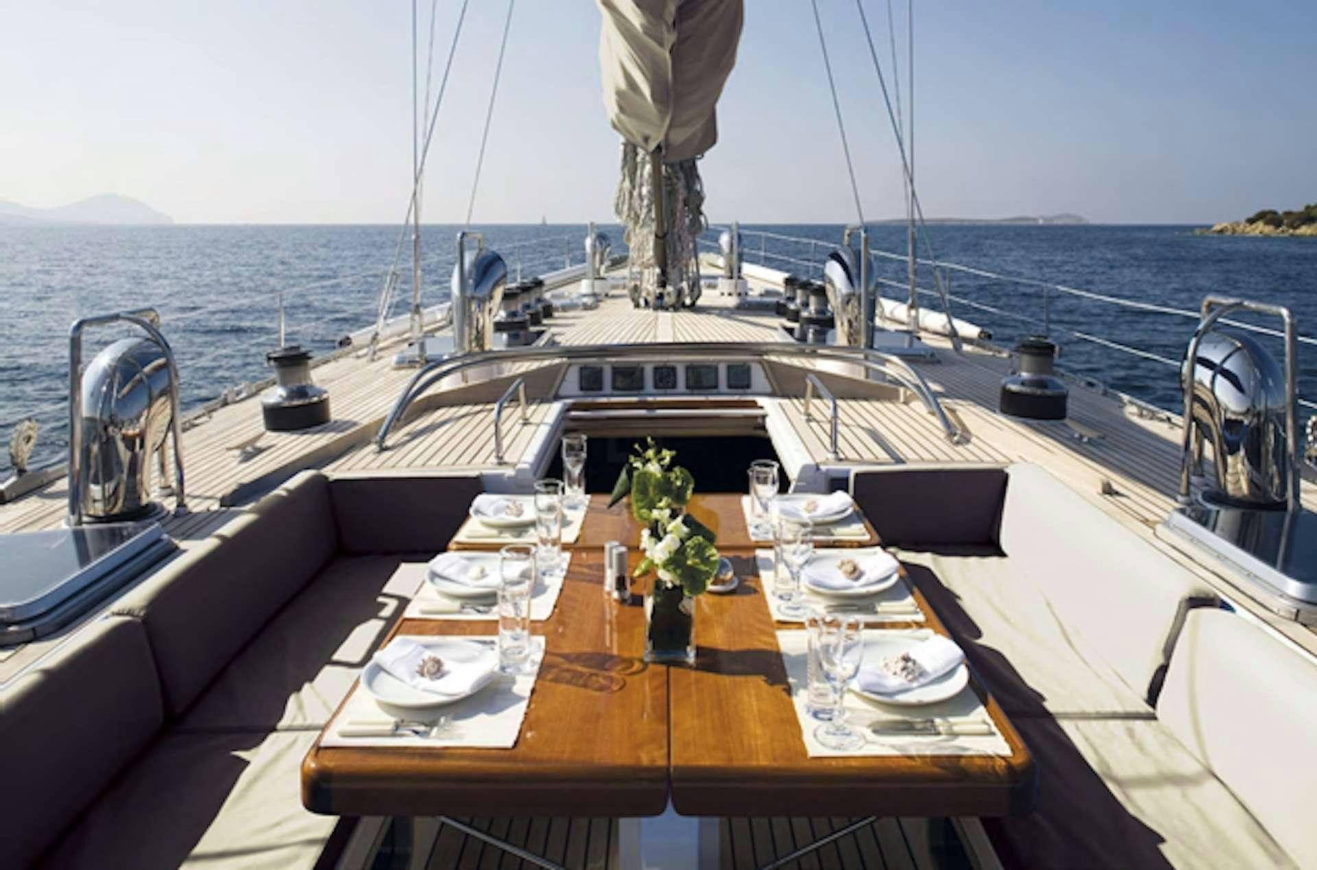 a table with plates and flowers on it aboard ABEON Yacht for Charter