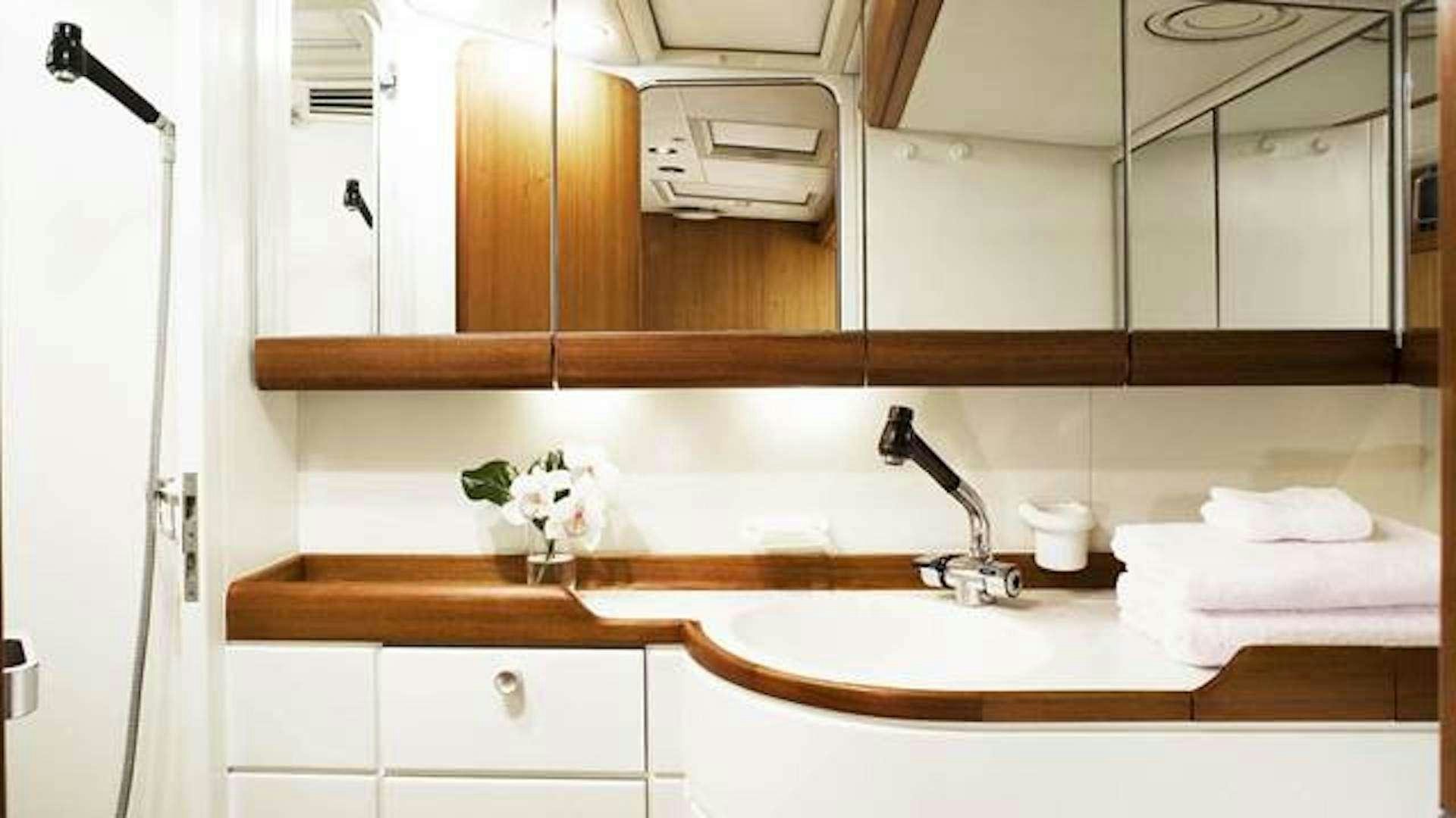 a bathroom with a sink and cabinets aboard ABEON Yacht for Charter