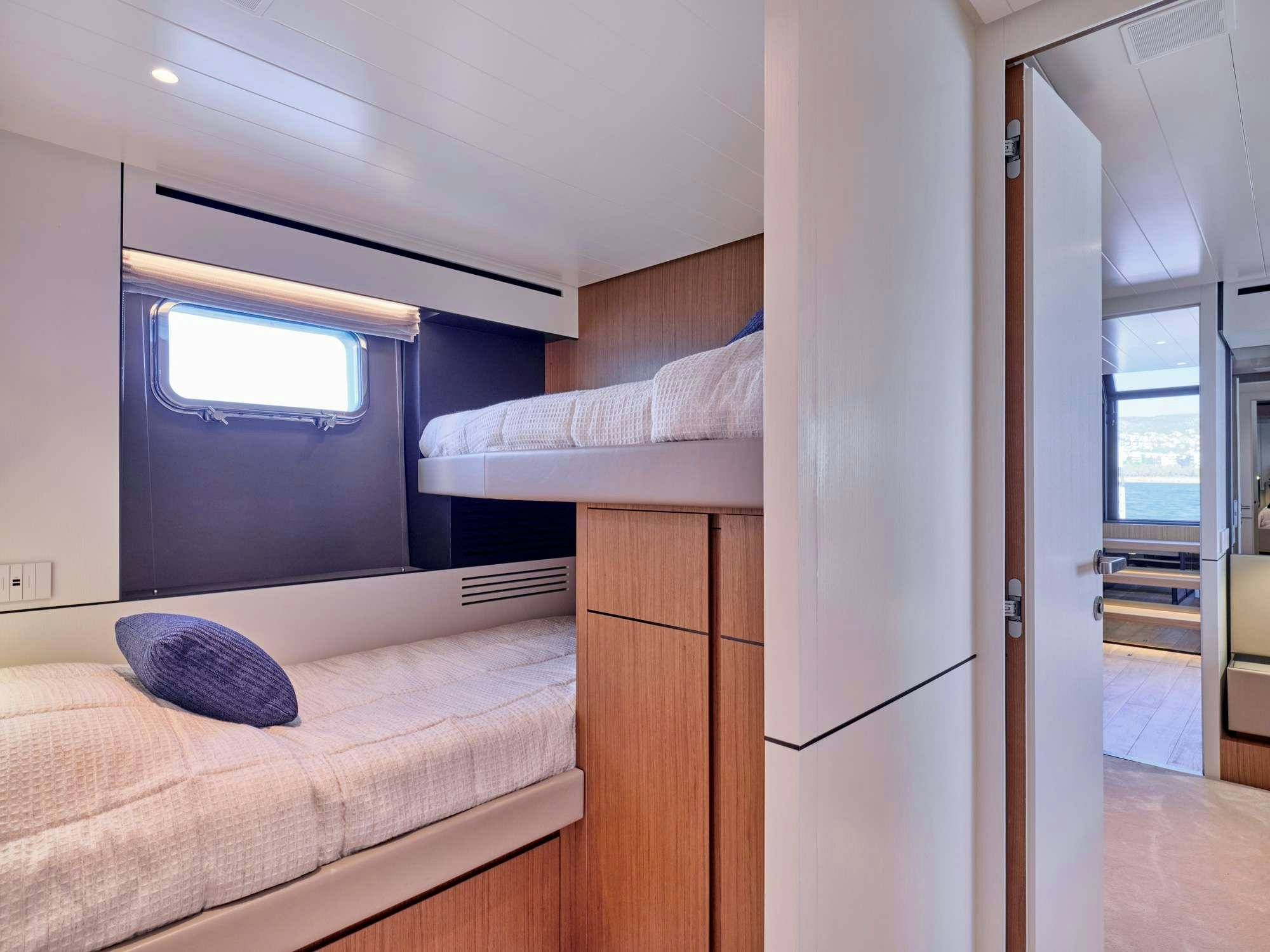 a room with a bed and a window aboard DUCHESS Yacht for Charter