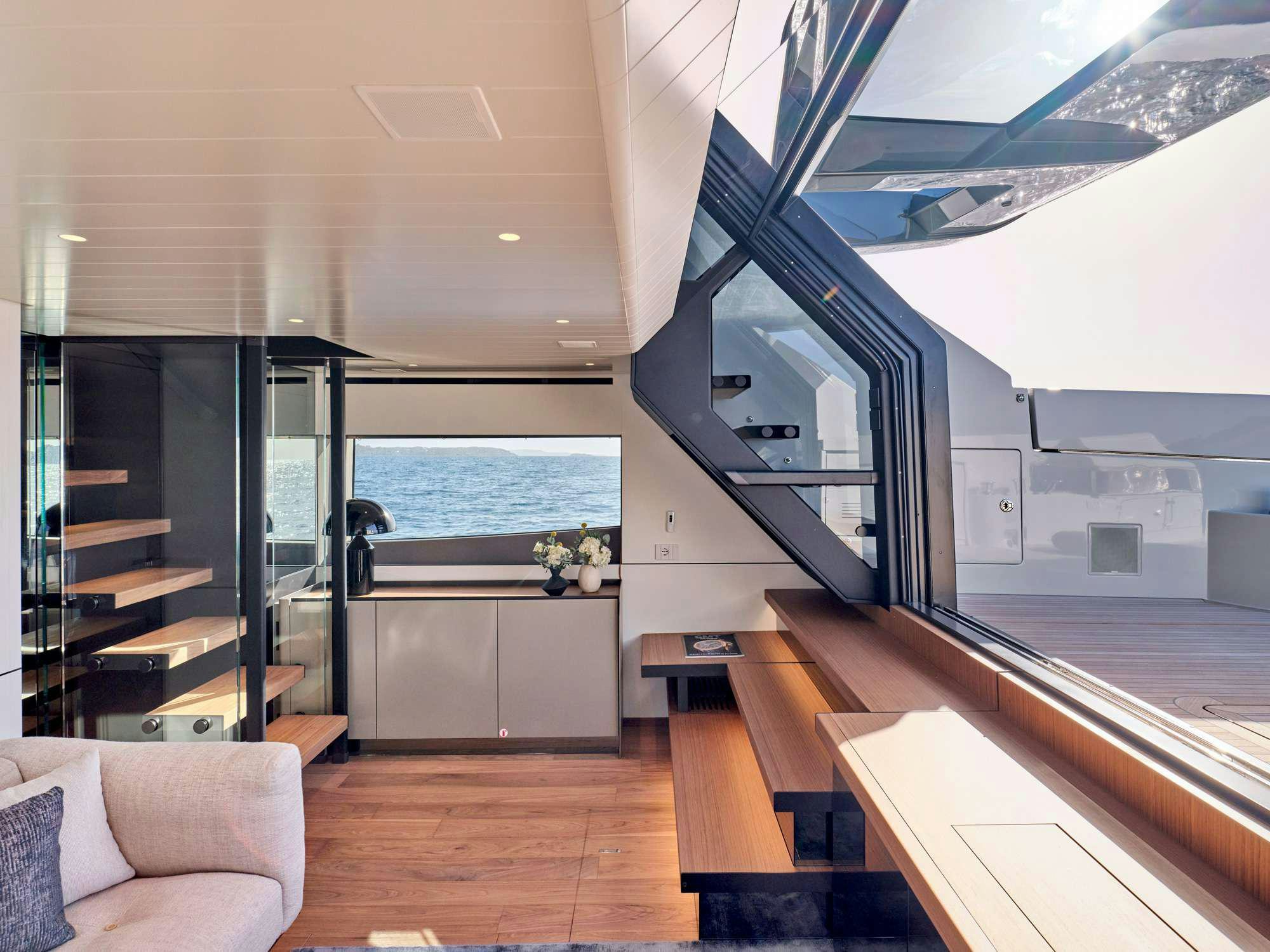 a modern looking living room with a large glass door and a large window aboard DUCHESS Yacht for Charter