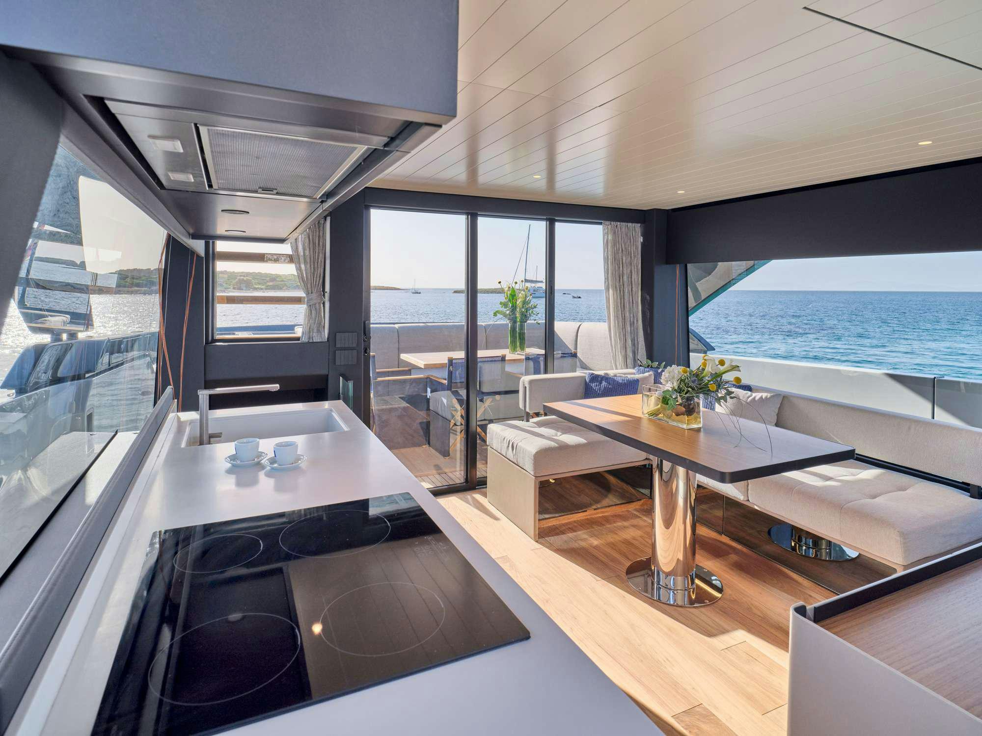a modern looking living room with a large balcony aboard DUCHESS Yacht for Charter