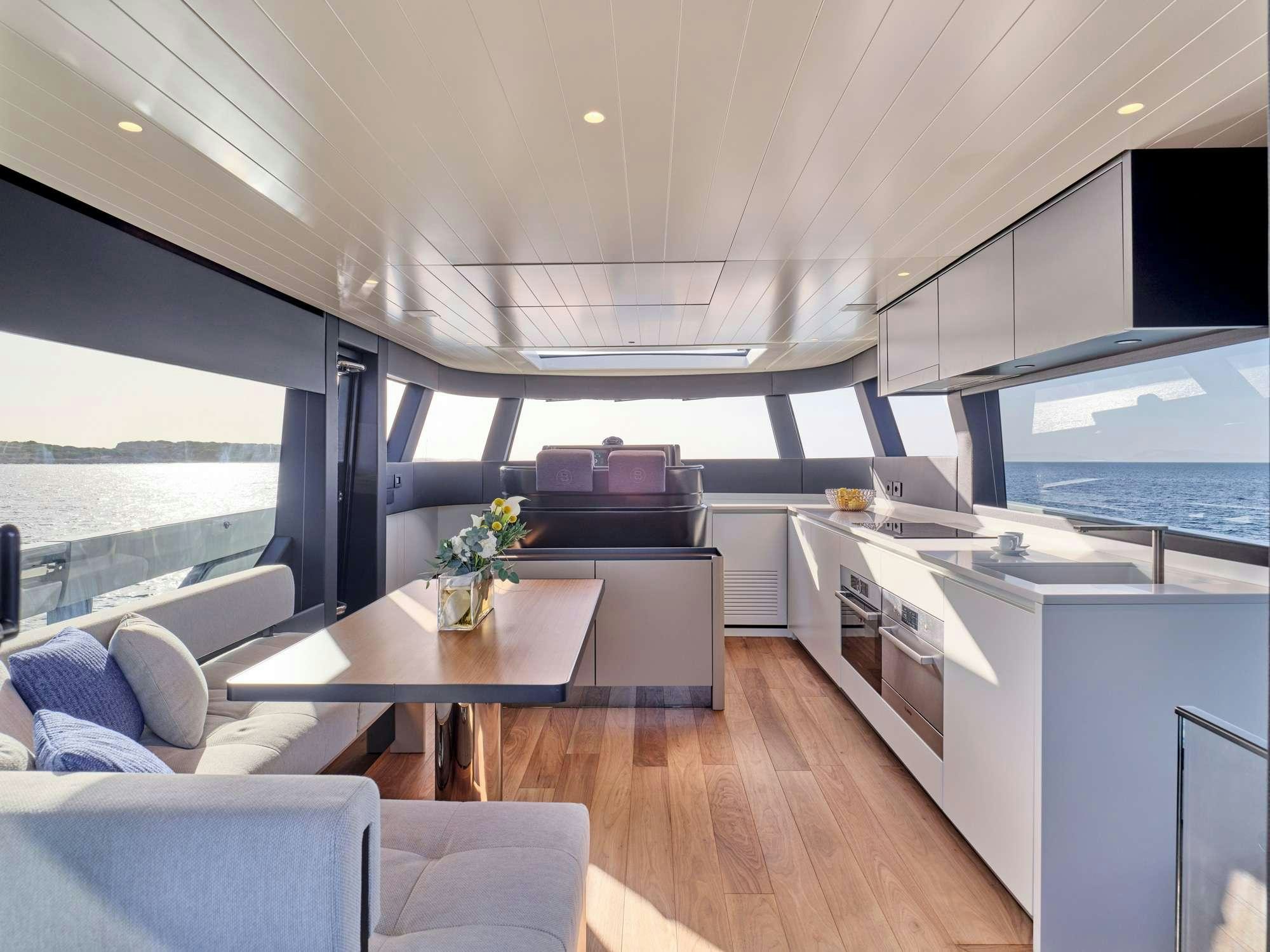 a modern looking living room with a large open window aboard DUCHESS Yacht for Charter
