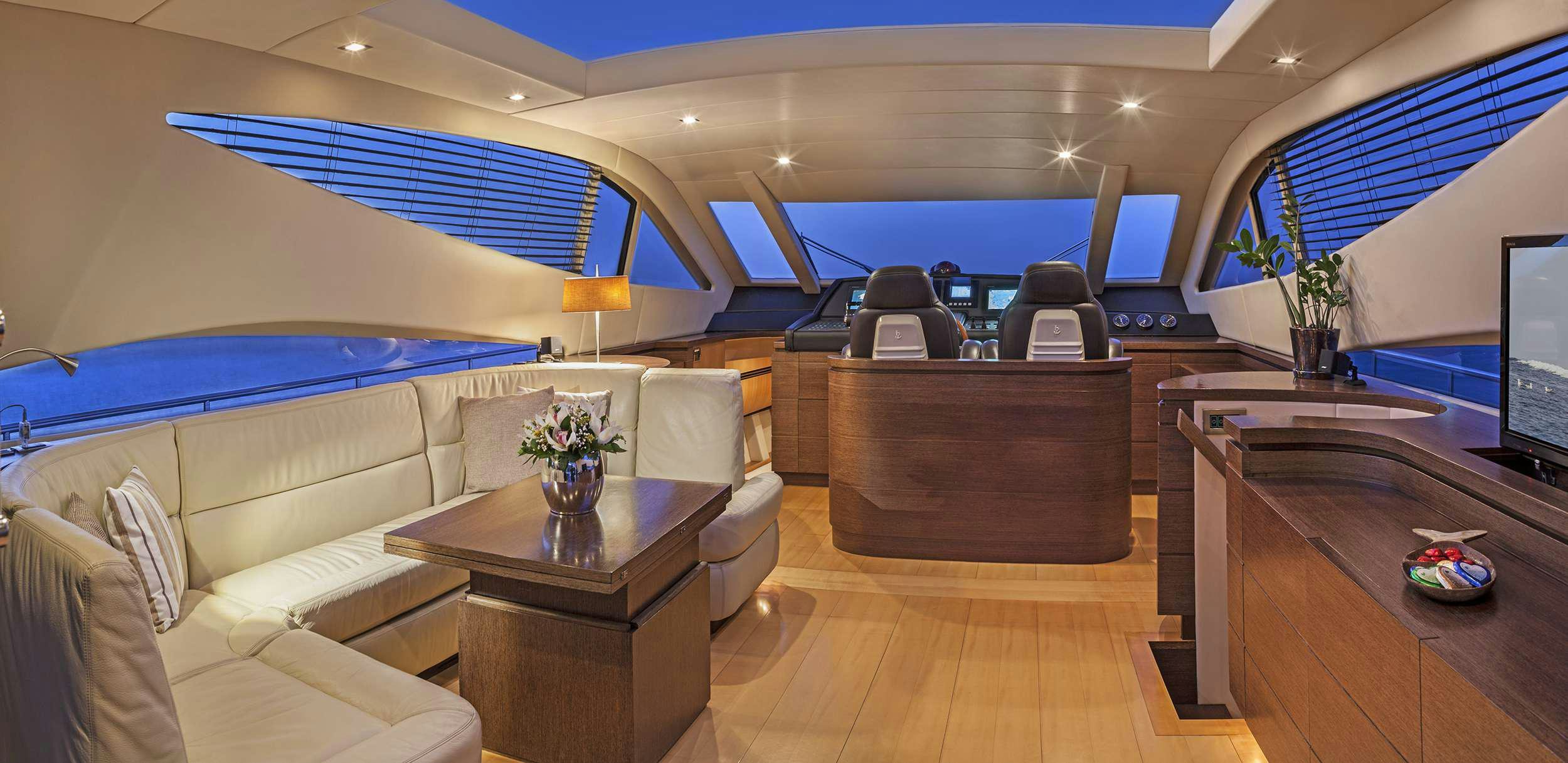 a room with a couch and a television aboard DUNE Yacht for Charter