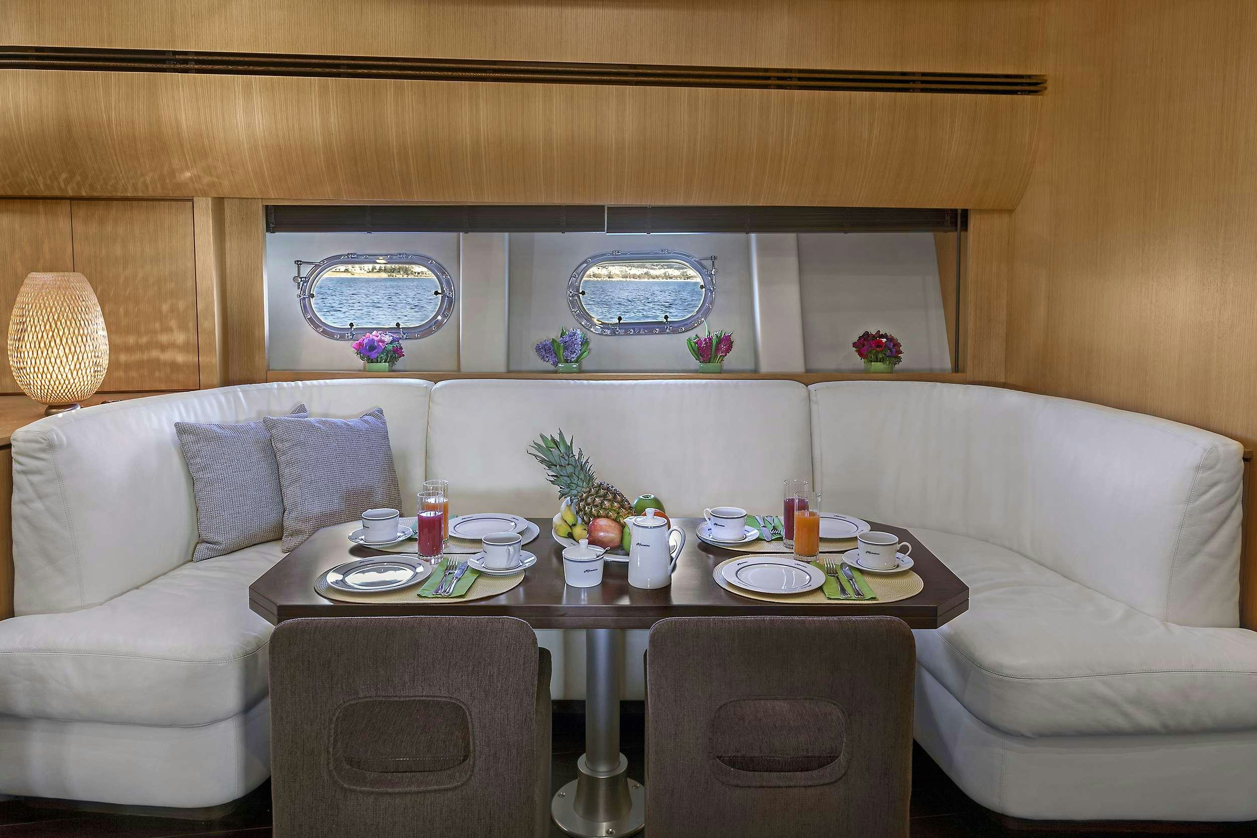 a table with plates and cups on it aboard DUNE Yacht for Charter
