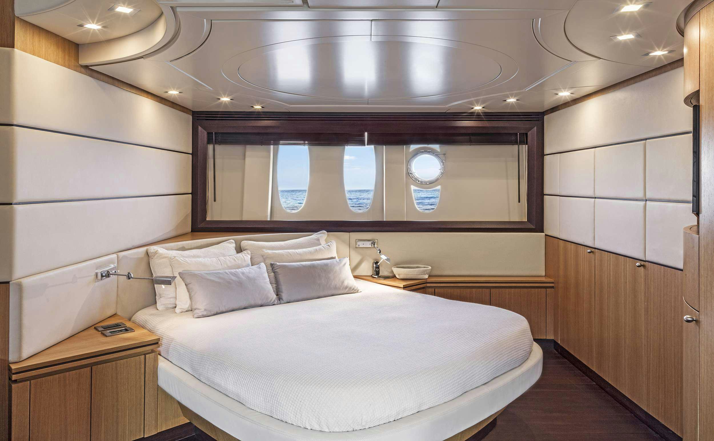 a room with a bed and a mirror aboard DUNE Yacht for Charter