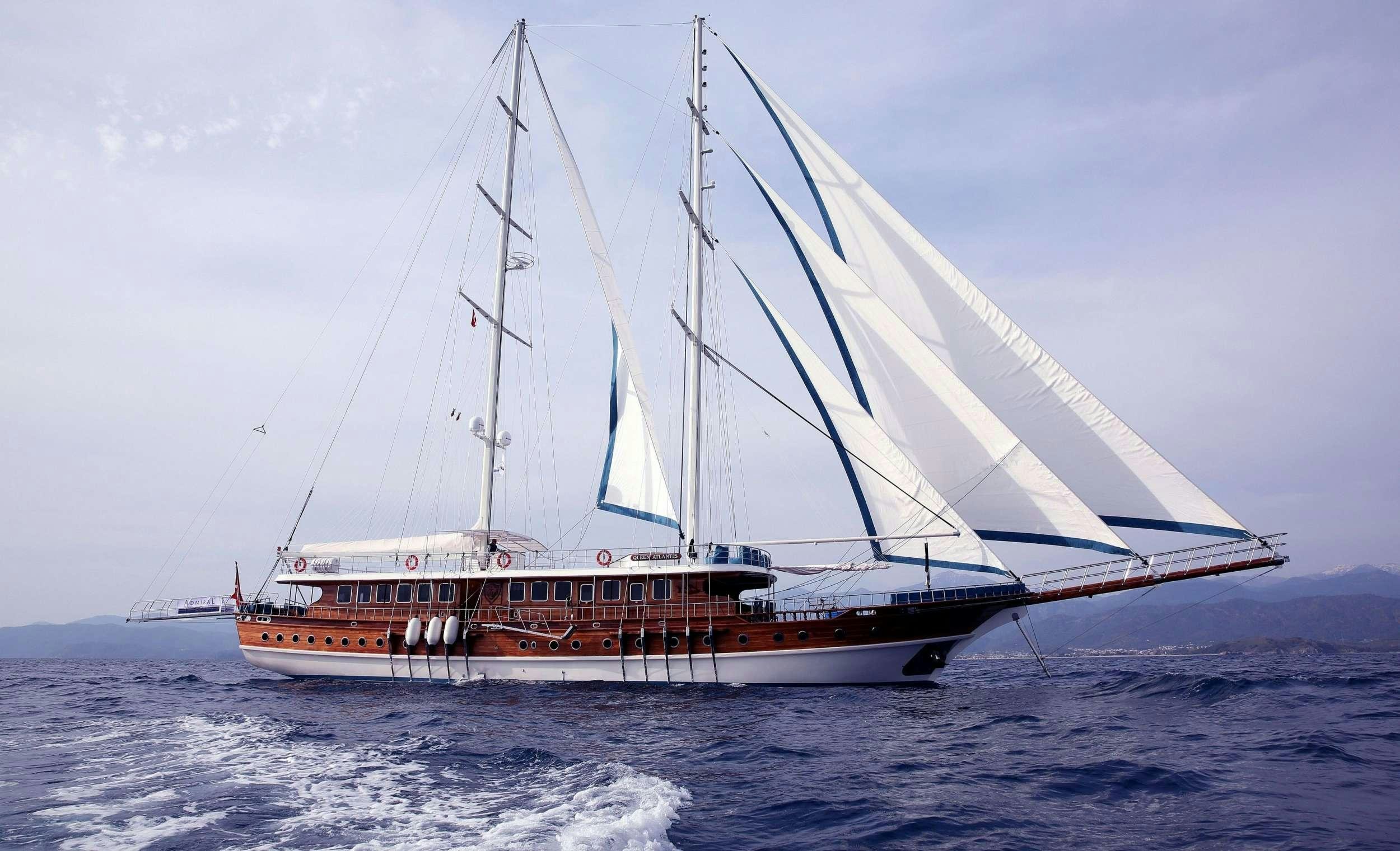 a boat sailing on the sea aboard QUEEN ATLANTIS Yacht for Charter