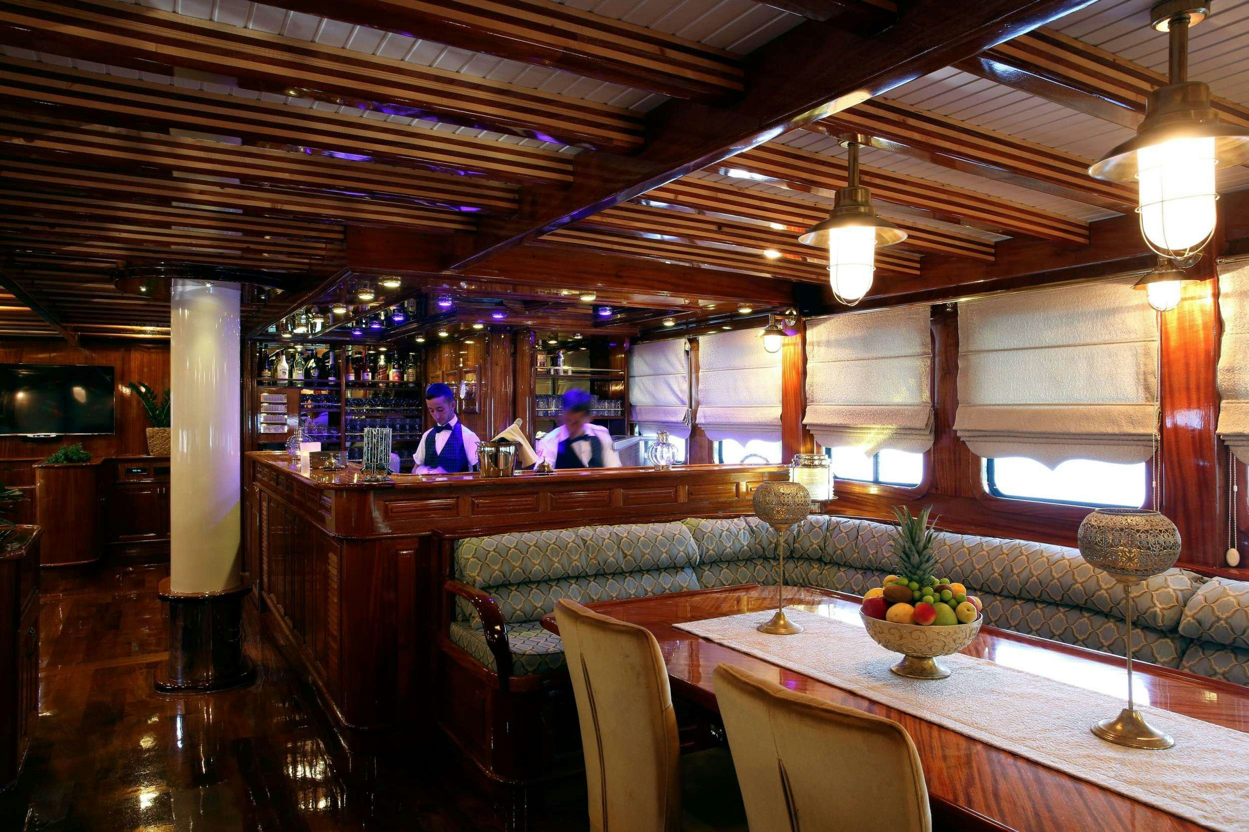 a restaurant with tables and chairs aboard QUEEN ATLANTIS Yacht for Charter