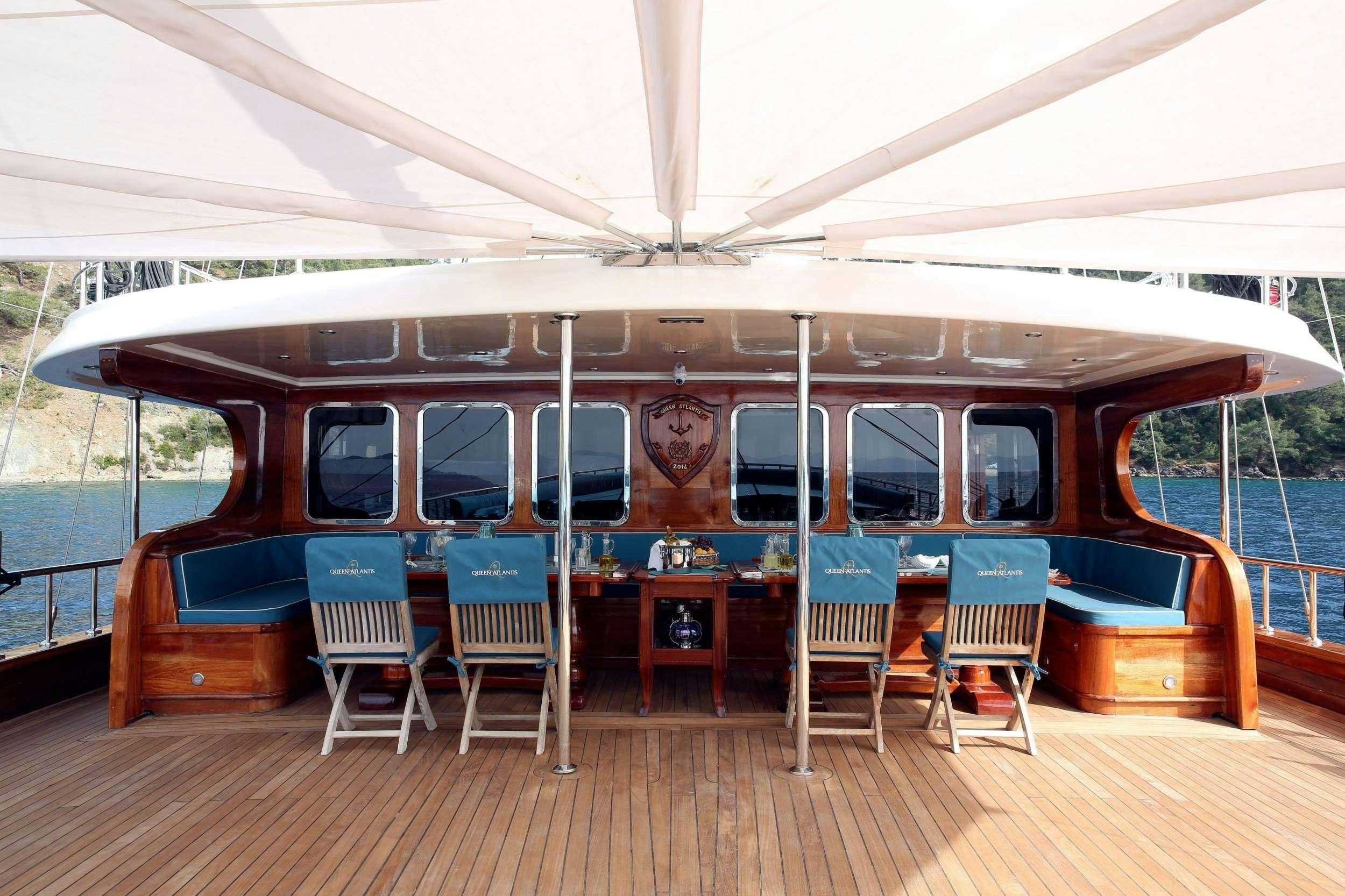 a boat on a dock aboard QUEEN ATLANTIS Yacht for Charter