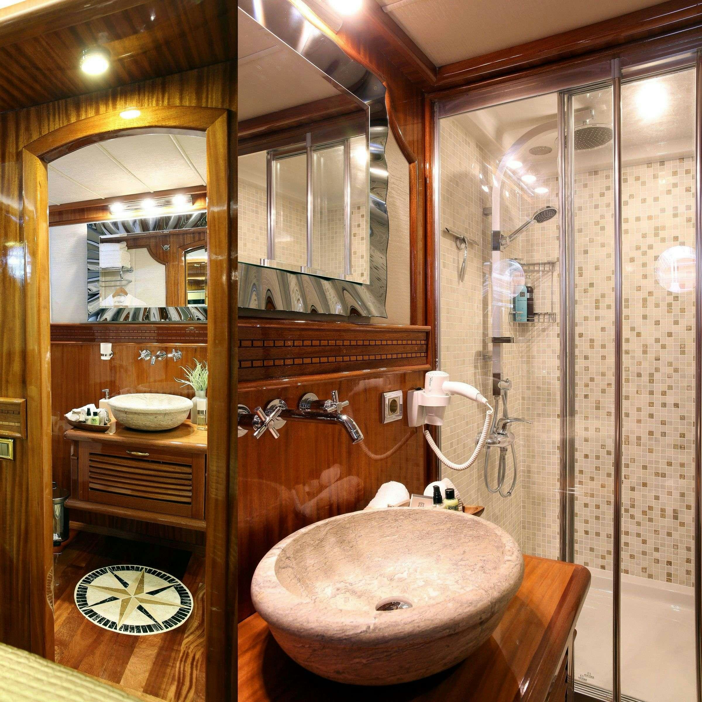 a bathroom with a round sink aboard QUEEN ATLANTIS Yacht for Charter