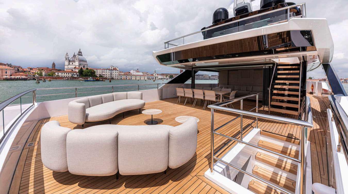 a balcony with a view of a city and water aboard VAYUS Yacht for Charter