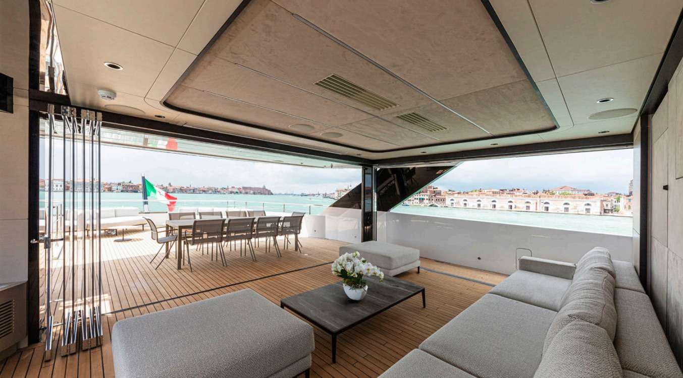 a living room with a large balcony aboard VAYUS Yacht for Charter