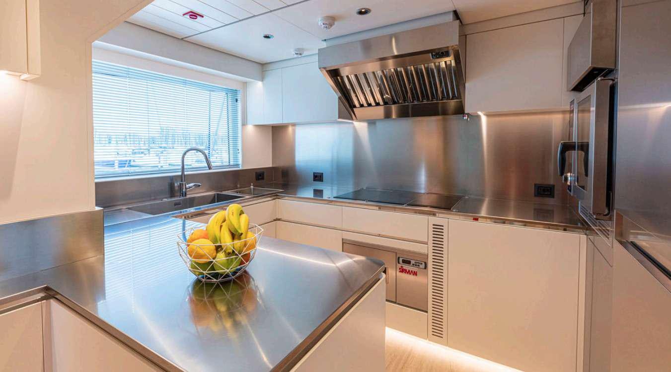 a kitchen with a stainless steel oven aboard VAYUS Yacht for Charter