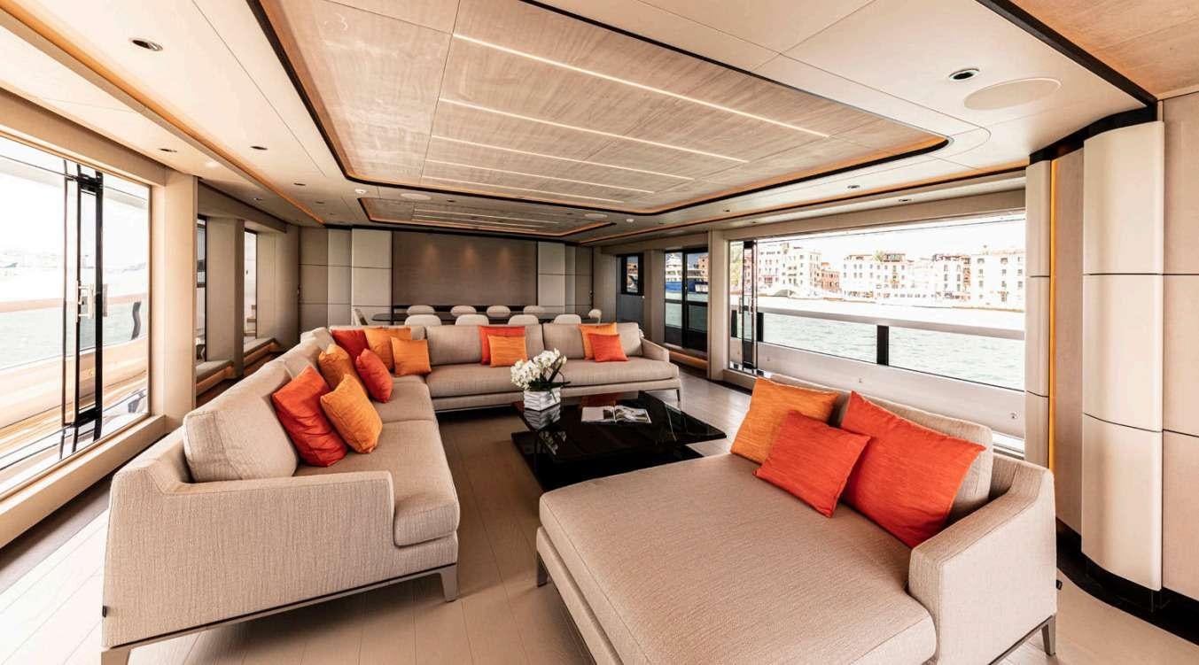 a living room with a large window aboard VAYUS Yacht for Charter