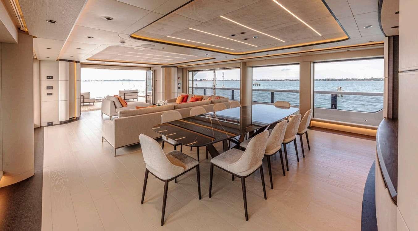 a large room with a table and chairs aboard VAYUS Yacht for Charter