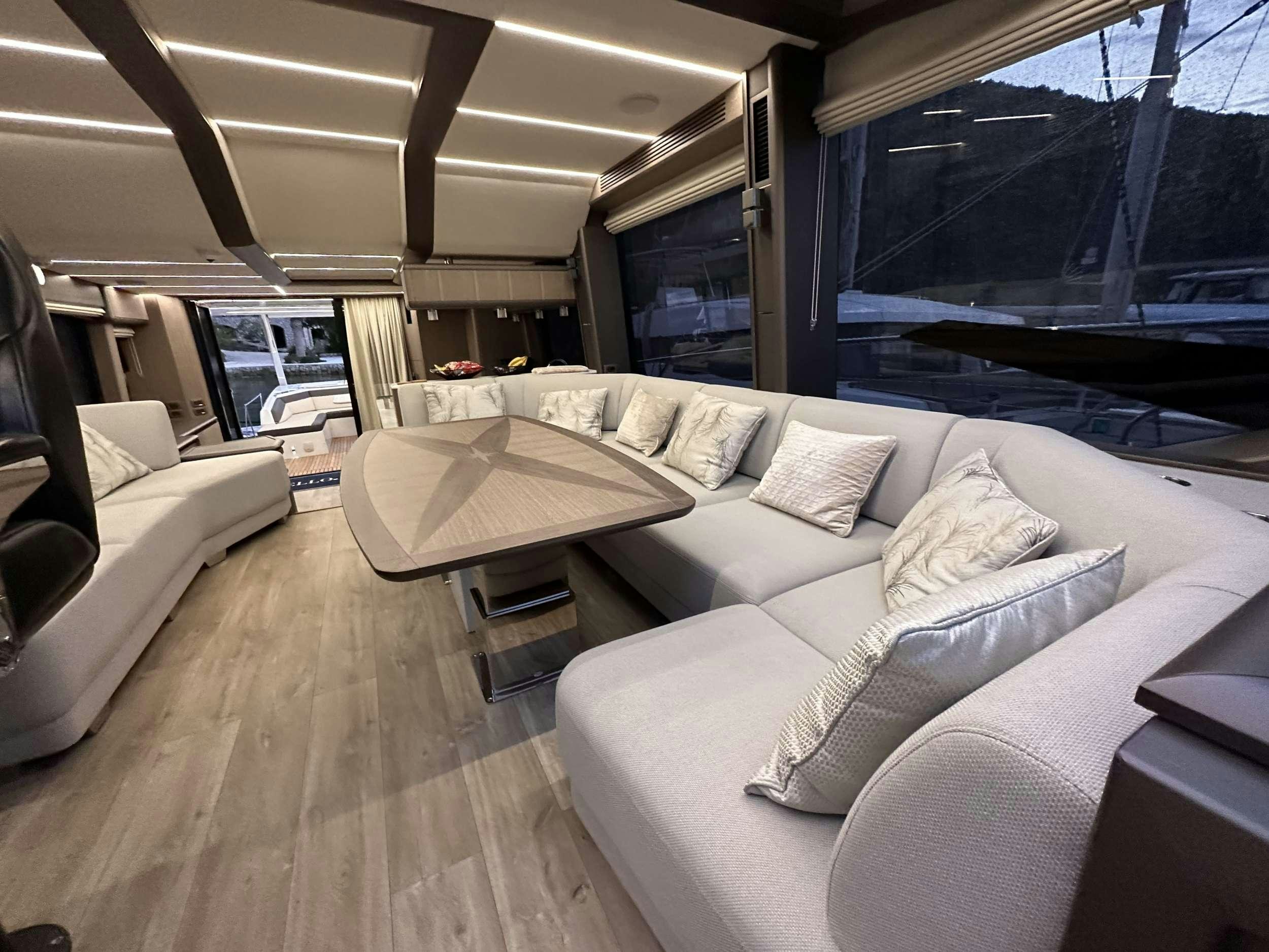a living room with a couch and a table aboard PARADISE Yacht for Charter