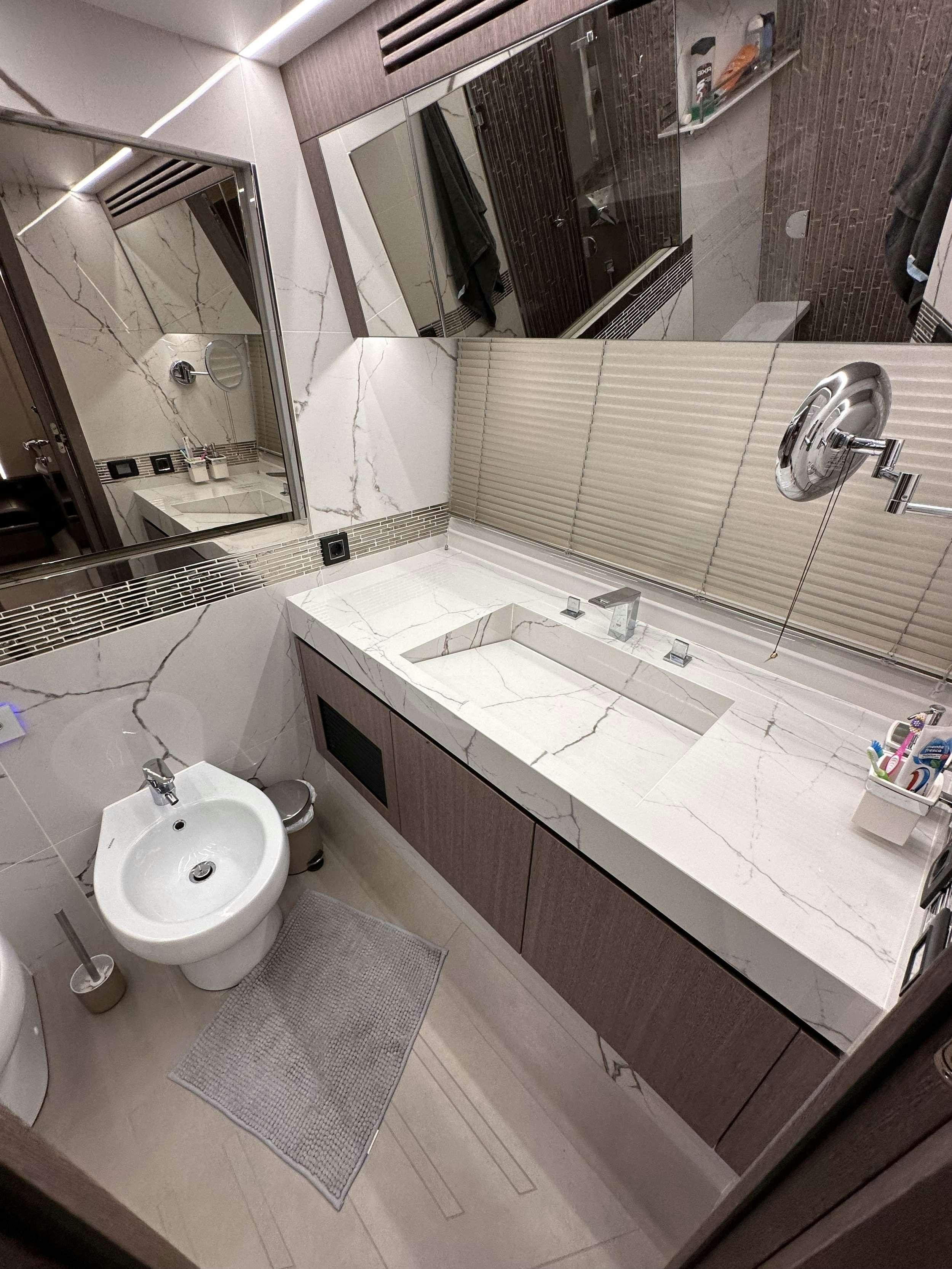 a bathroom with a large mirror aboard PARADISE Yacht for Charter