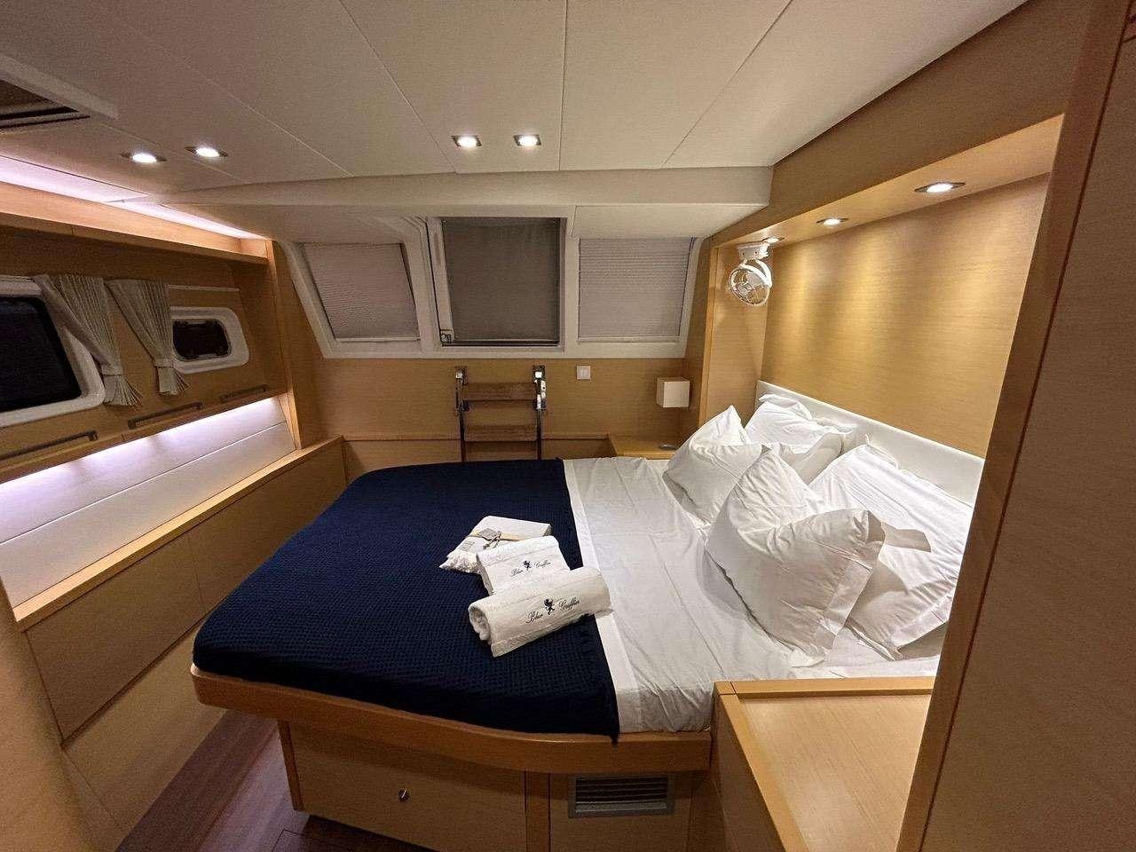 a room with a bed and a desk aboard BLUE GRIFFIN - SUMMER Yacht for Charter