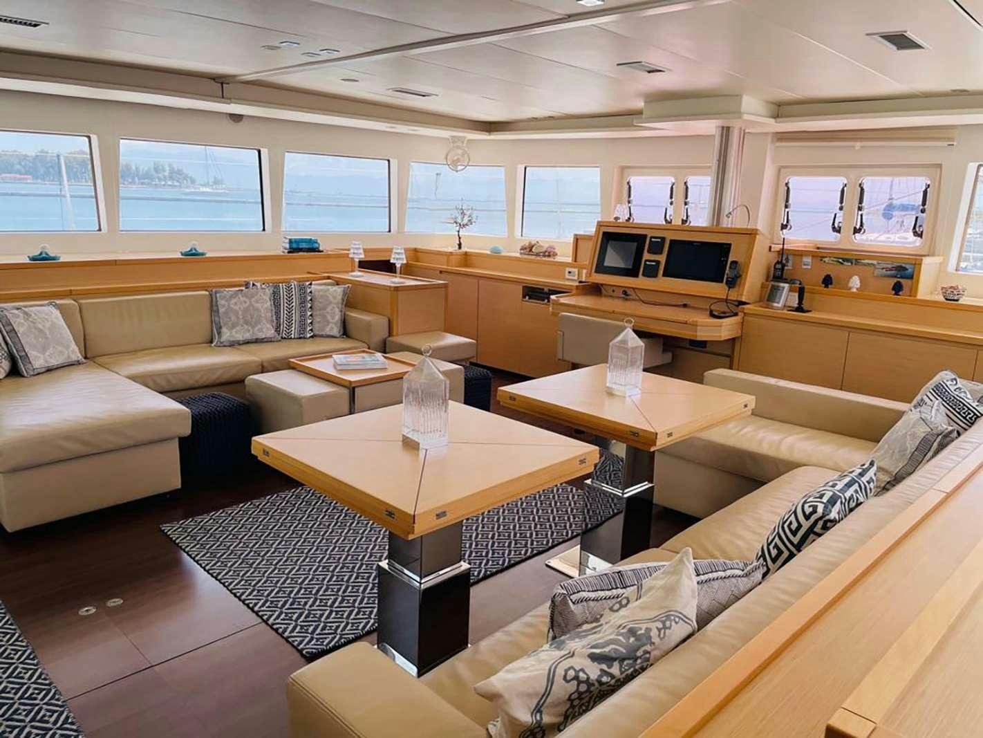 a living room with a table and couches aboard BLUE GRIFFIN - SUMMER Yacht for Charter