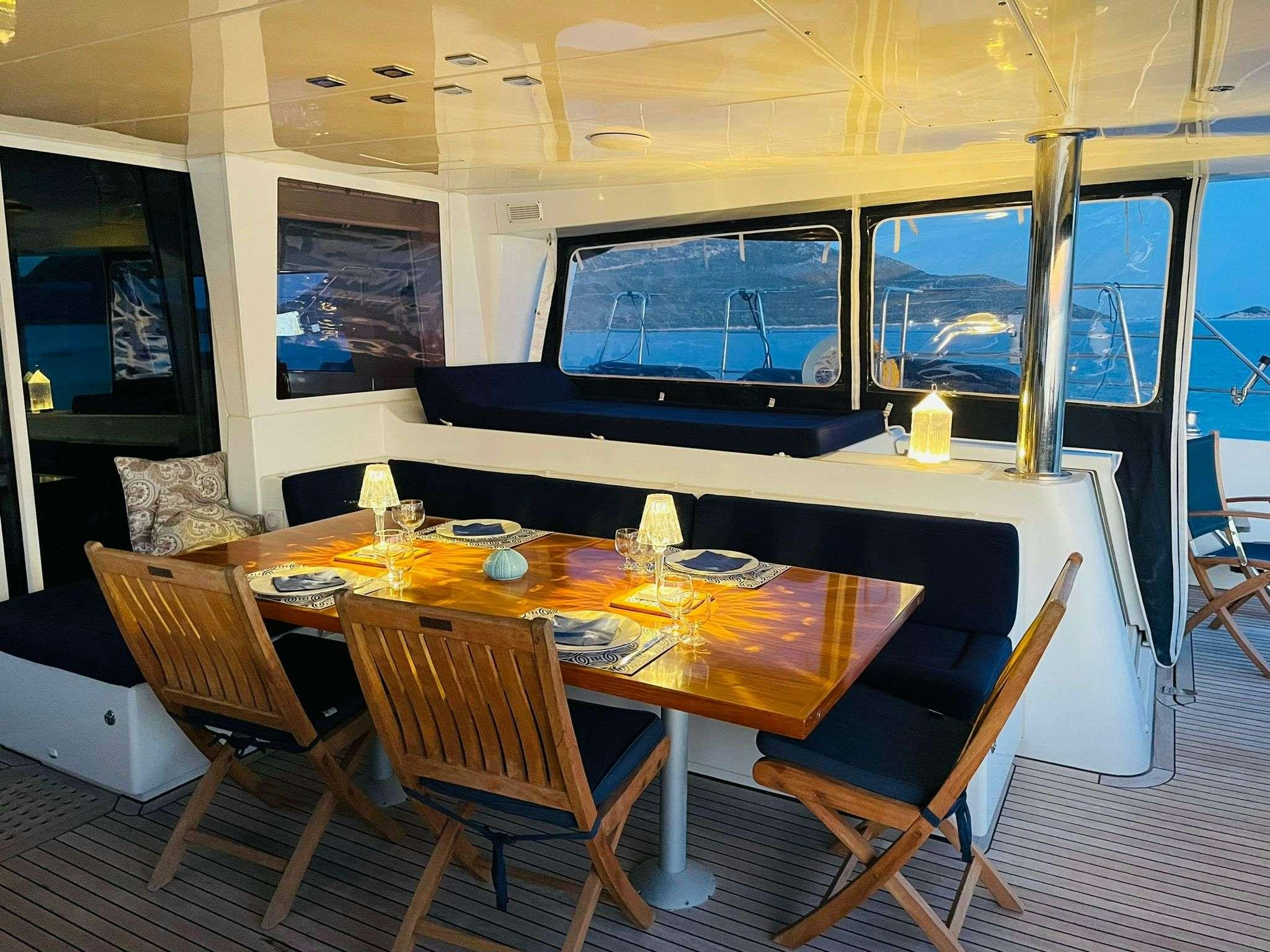 a table with chairs around it aboard BLUE GRIFFIN - SUMMER Yacht for Charter
