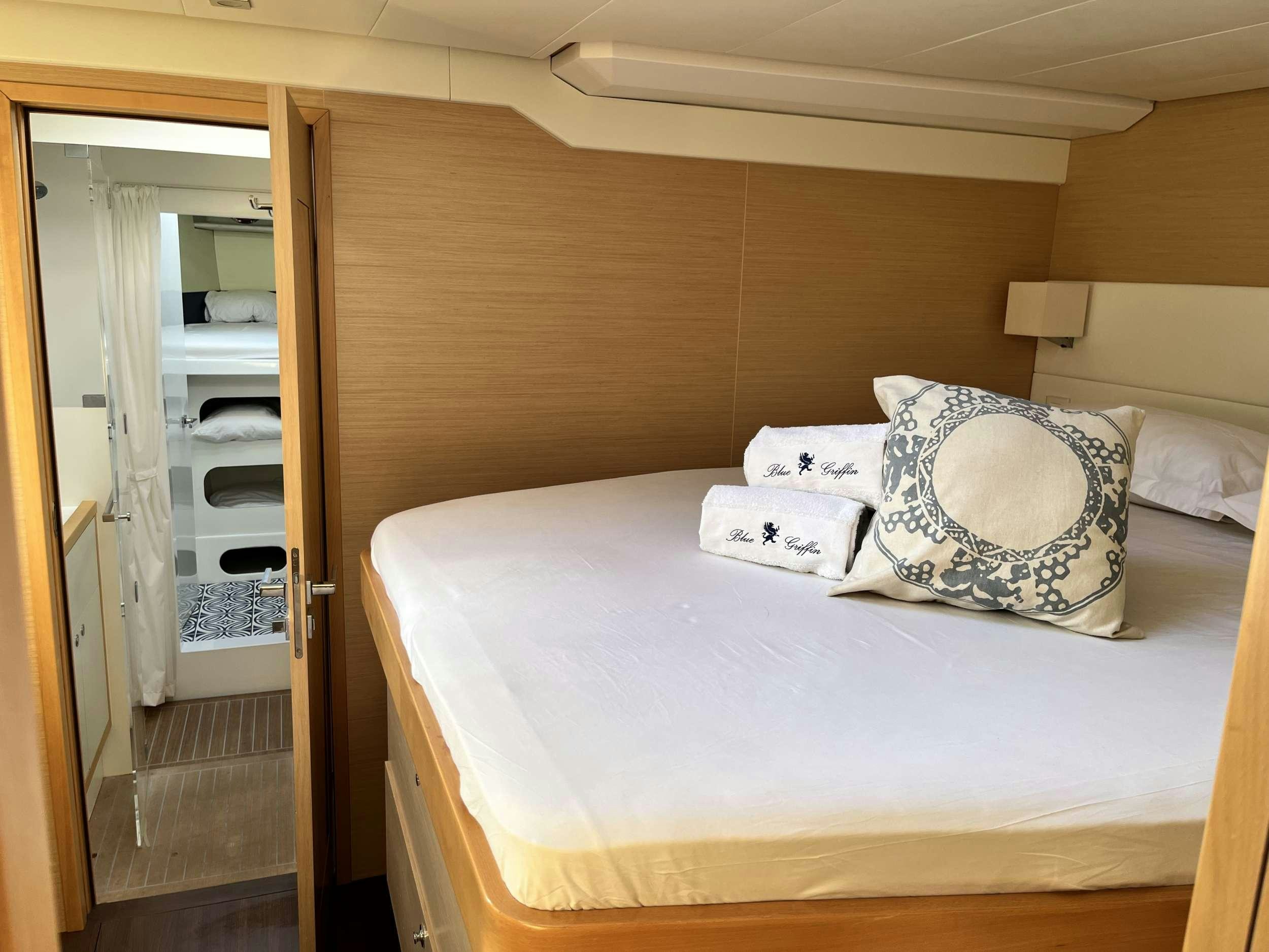 a bed with a pillow on it aboard BLUE GRIFFIN - SUMMER Yacht for Charter