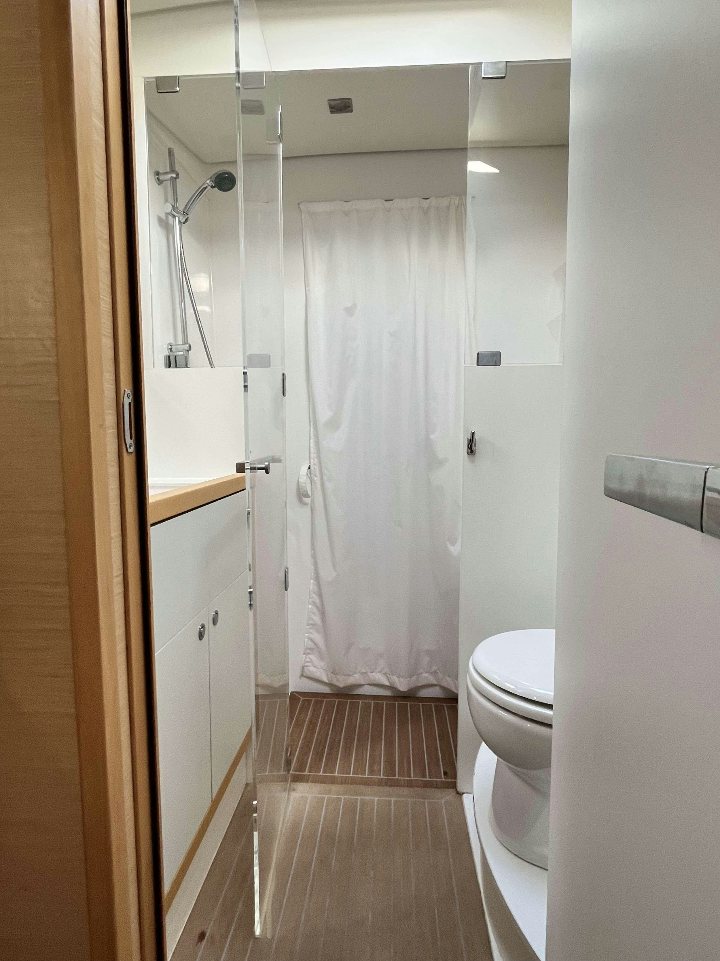 a bathroom with a shower curtain aboard BLUE GRIFFIN - SUMMER Yacht for Charter