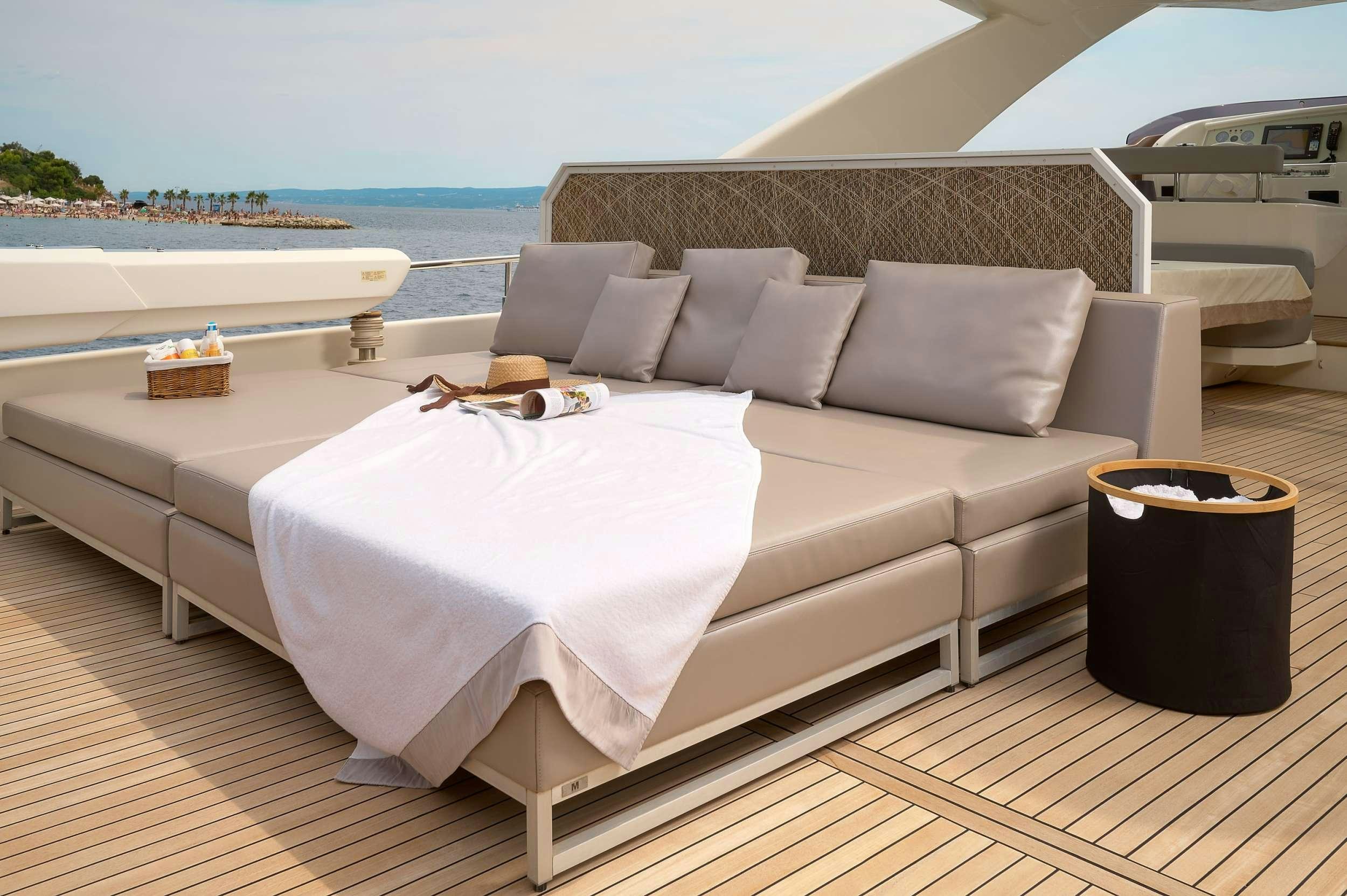 a bed on a deck aboard IVA Yacht for Charter