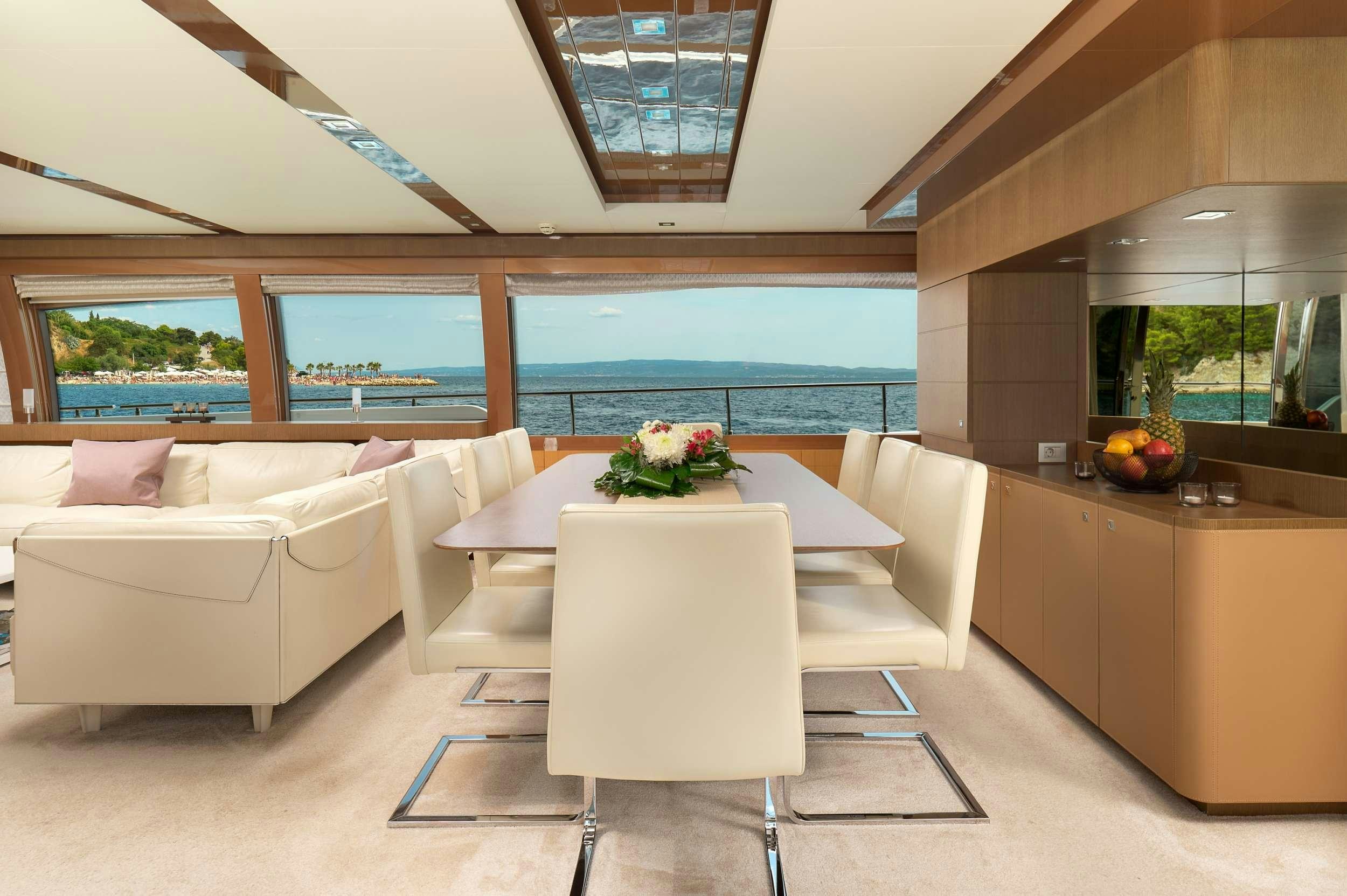 a room with a couch and a table aboard IVA Yacht for Charter