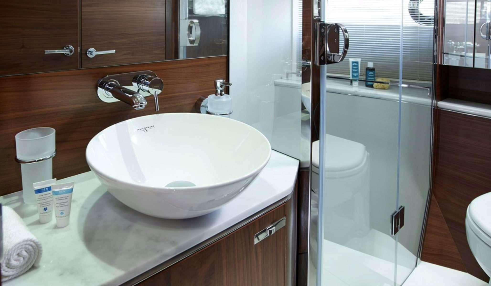 a bathroom sink with a mirror aboard FAR & AWAY Yacht for Charter