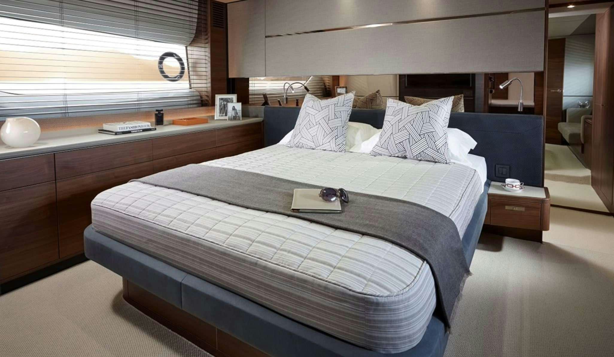 a bed with a blue bed spread aboard FAR & AWAY Yacht for Charter