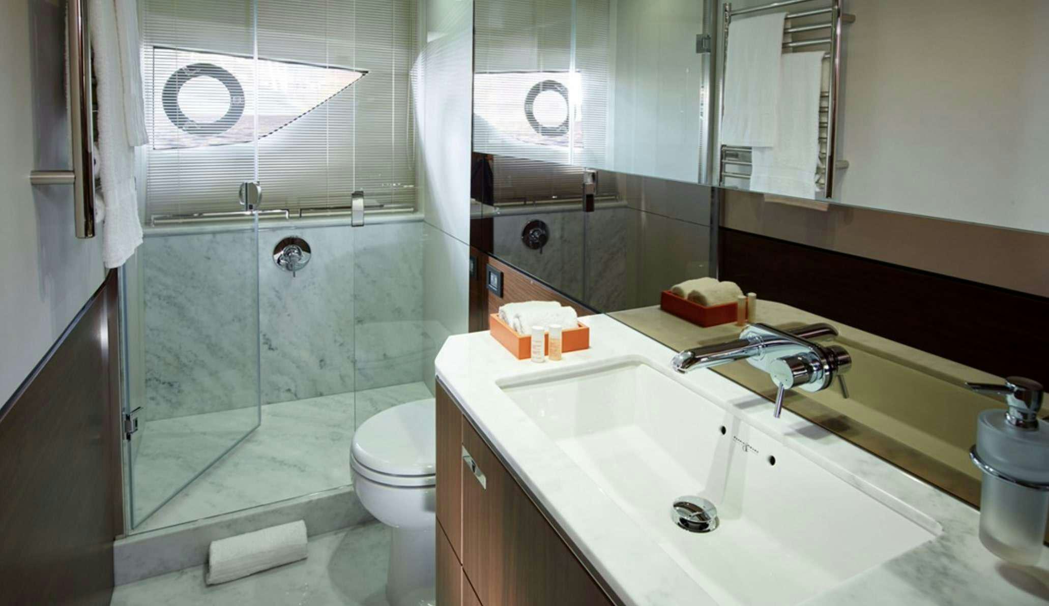 a bathroom with a glass shower aboard FAR & AWAY Yacht for Charter
