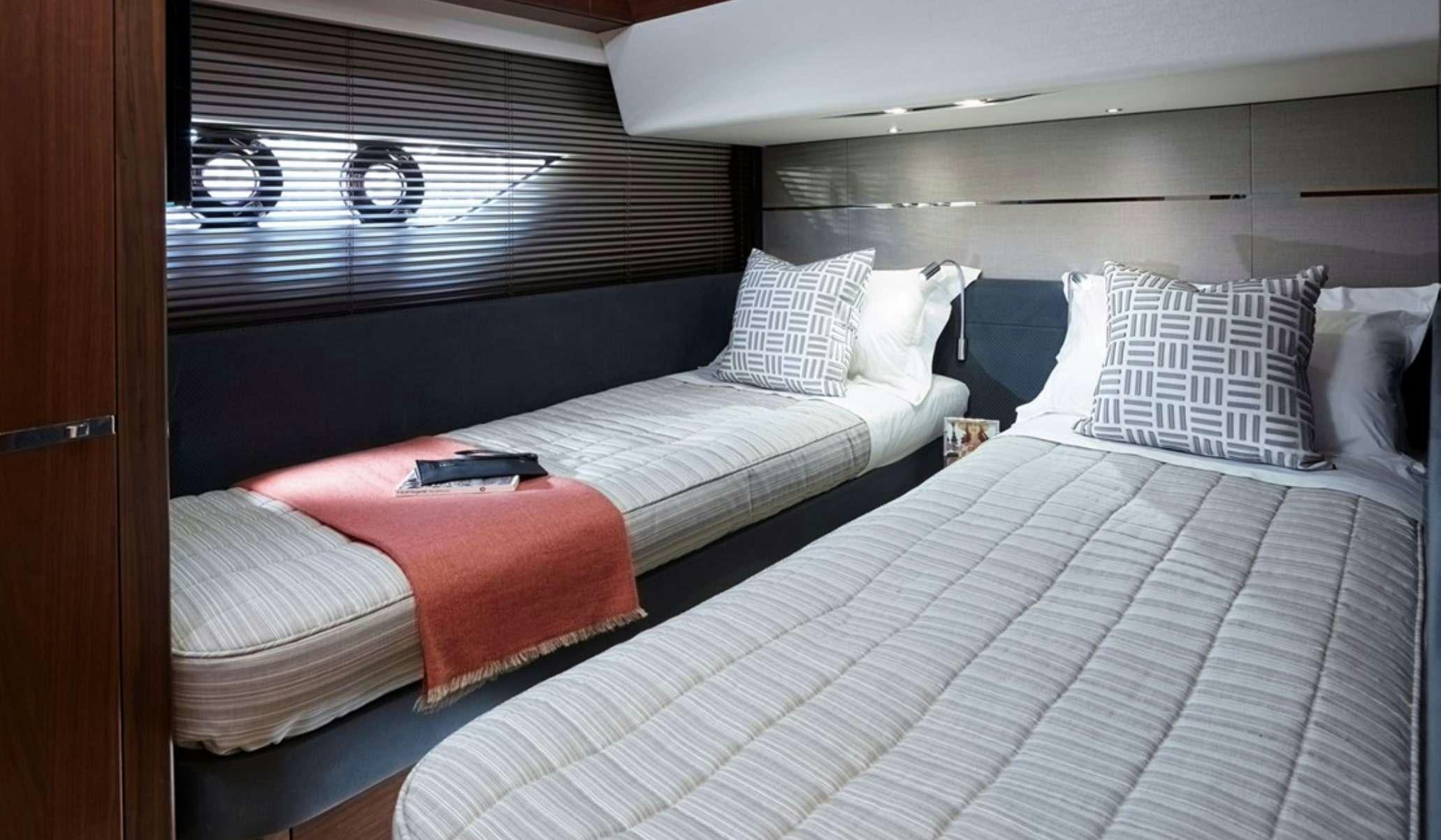 a couple of beds in a room aboard FAR & AWAY Yacht for Charter