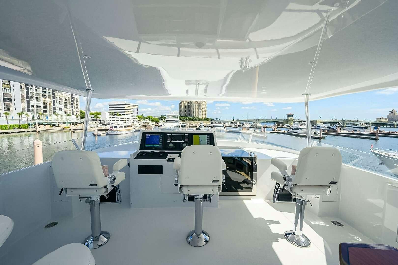 a group of white chairs under a tent aboard HARD TIMES Yacht for Charter