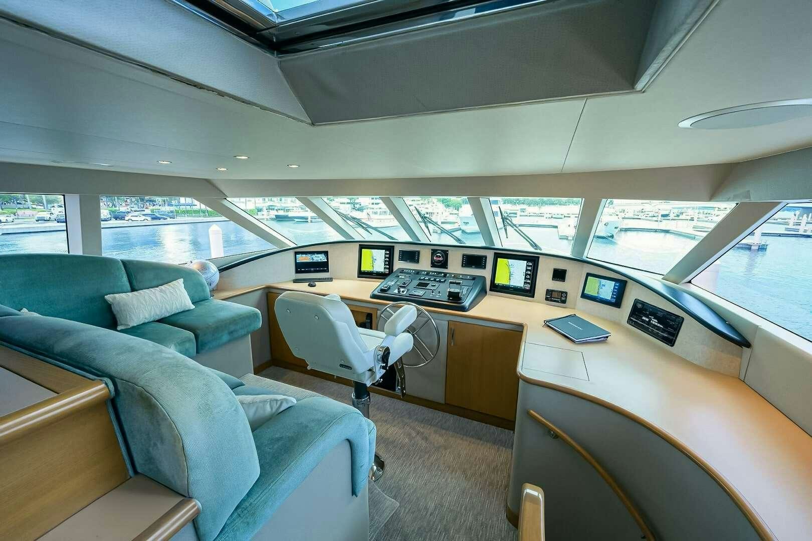 inside of a vehicle with a desk and chairs and computers aboard HARD TIMES Yacht for Charter
