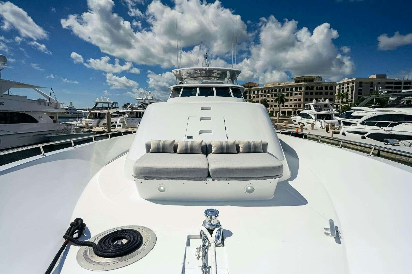 a white yacht in a harbor aboard HARD TIMES Yacht for Charter