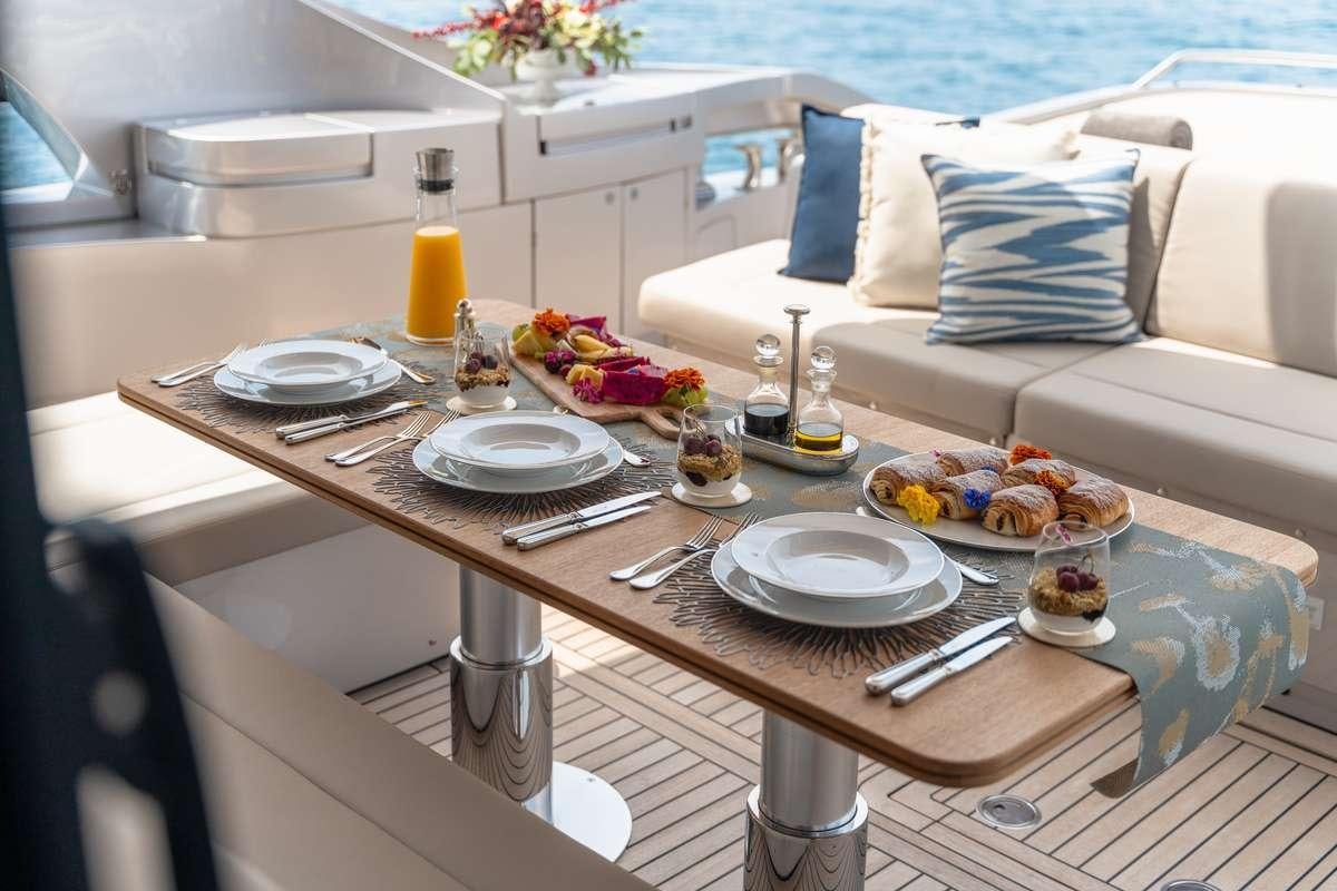 a table with plates and food on it aboard CHERRY Yacht for Charter