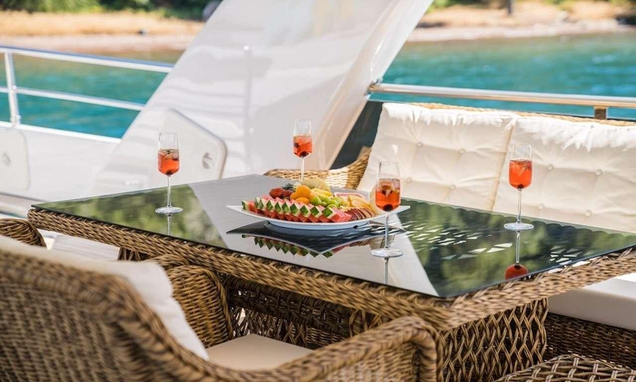 a table with food and drinks on it aboard DEEP WATER Yacht for Charter