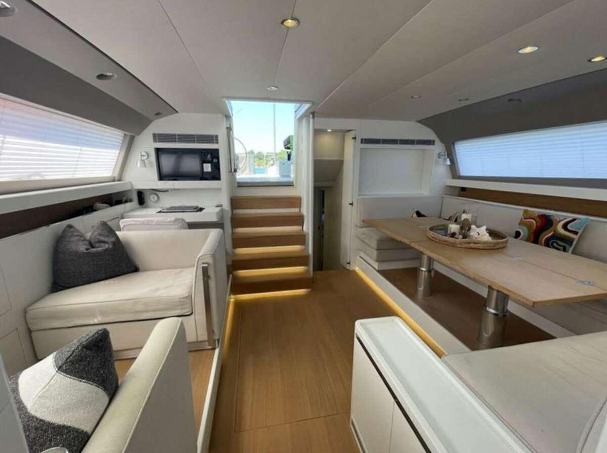 a living room with a couch and a television aboard BUBBLES Yacht for Charter
